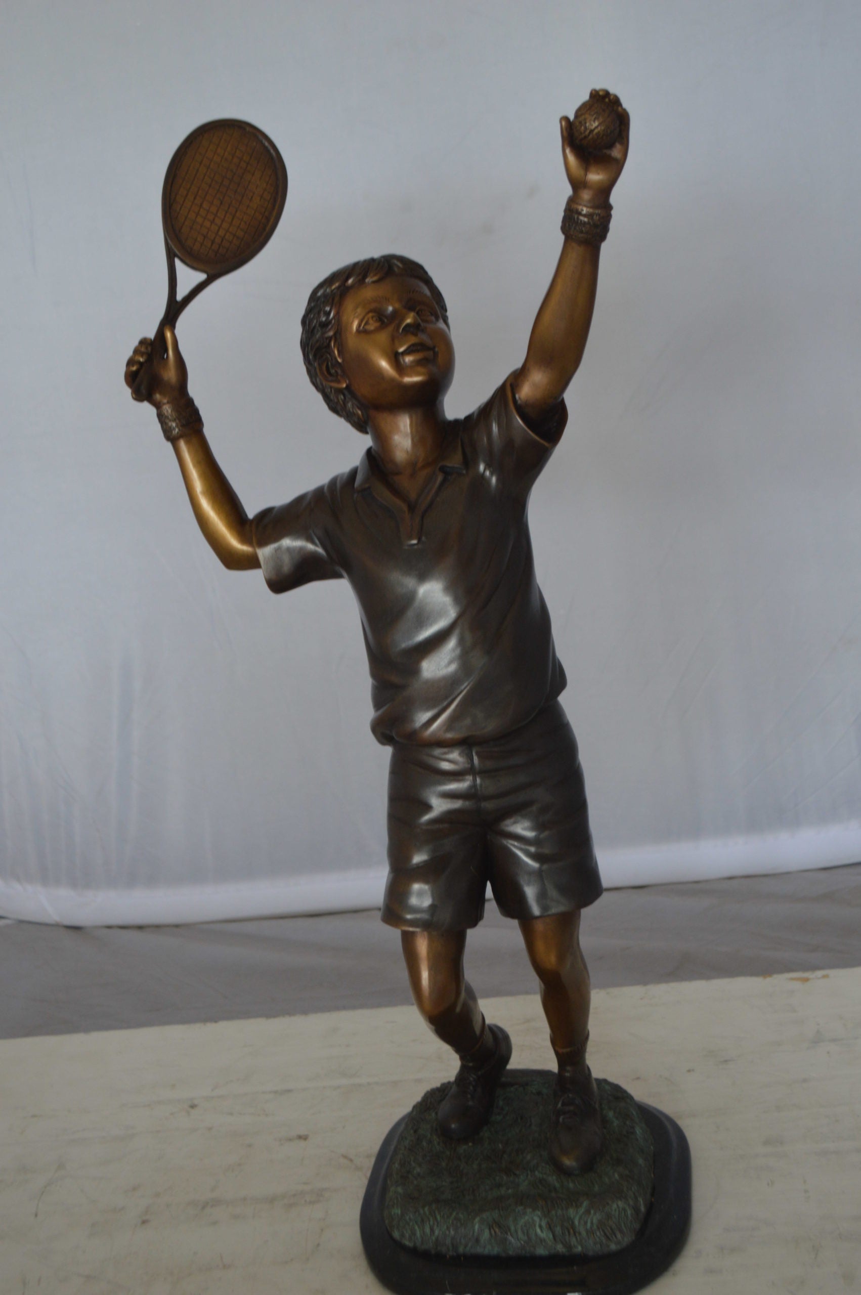 Boy Playing Tennis Bronze Statue -  Size: 12"L x 8"W x 25"H. 