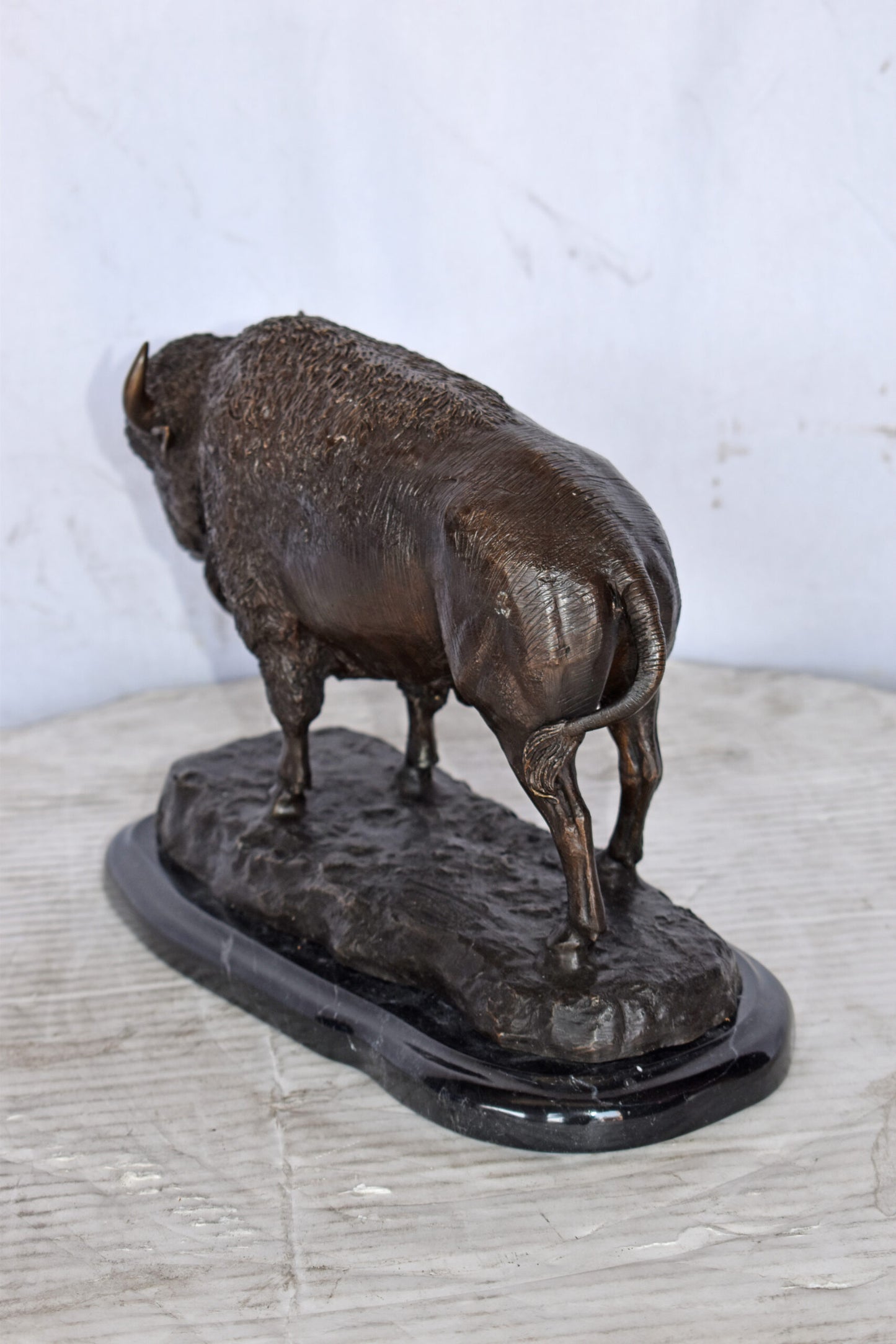 Bison standing and looking down Bronze Statue - Size: 11"L x 6"W x 8"H.