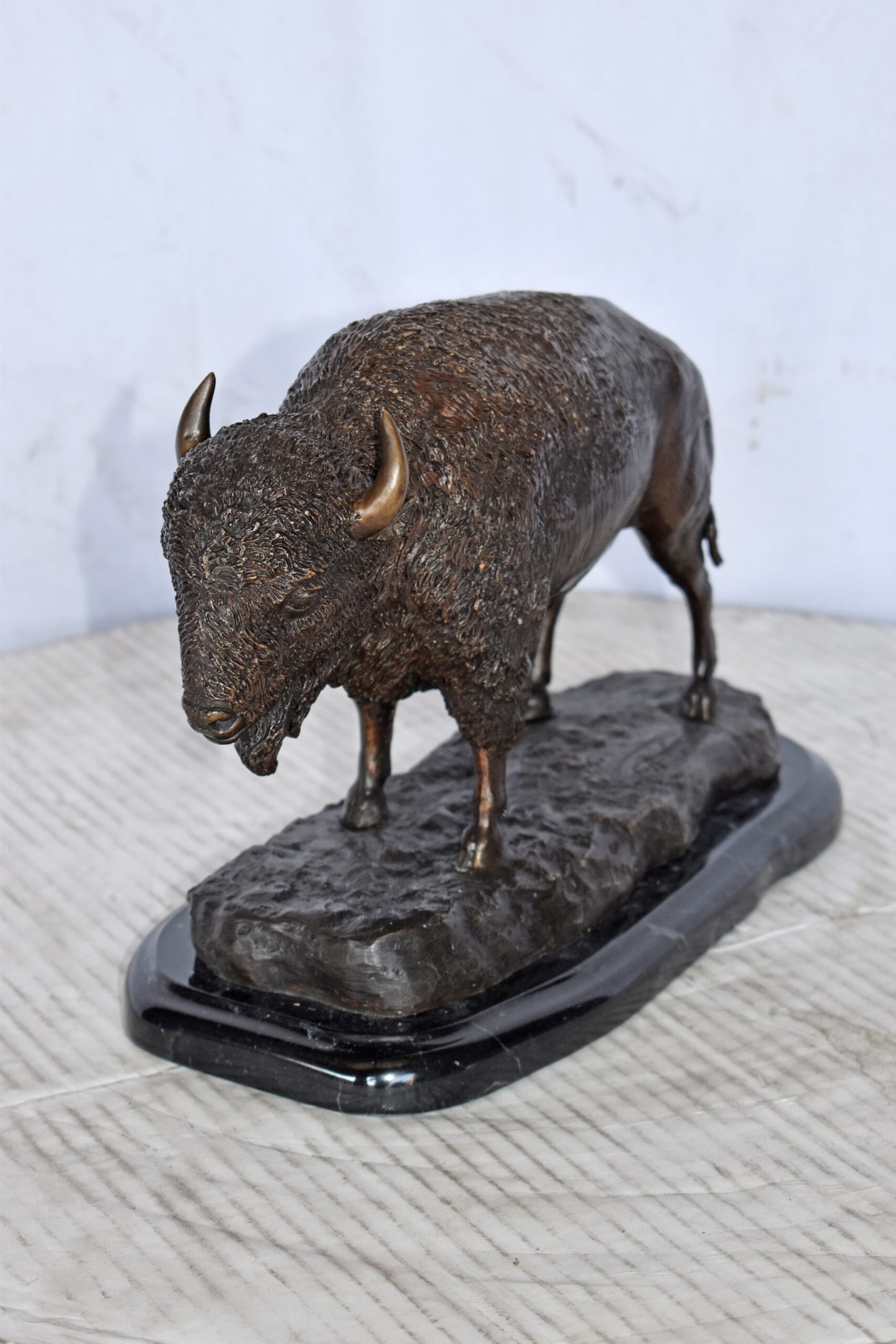 Bison standing and looking down Bronze Statue - Size: 11"L x 6"W x 8"H.