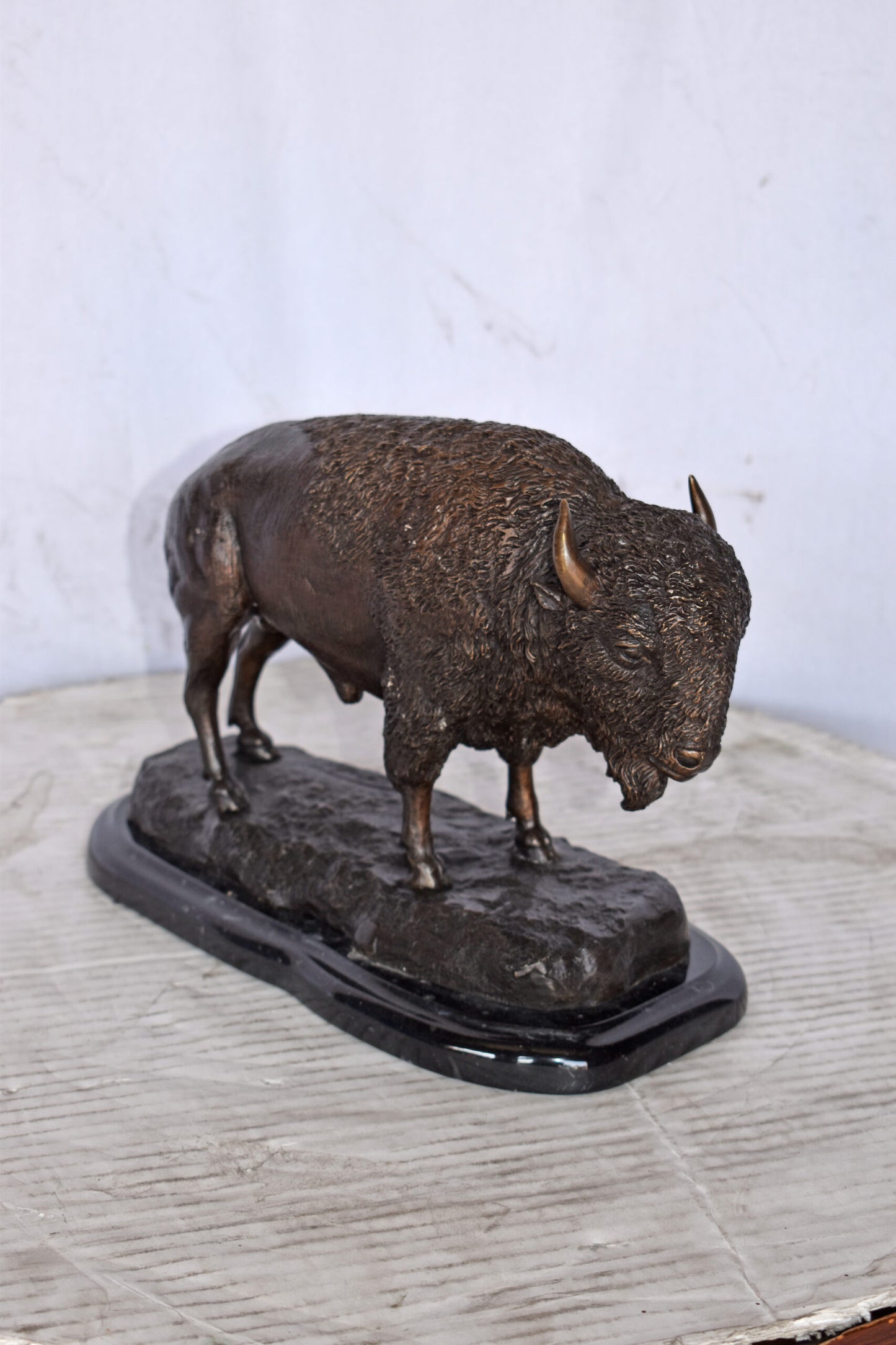 Bison standing and looking down Bronze Statue - Size: 11"L x 6"W x 8"H.