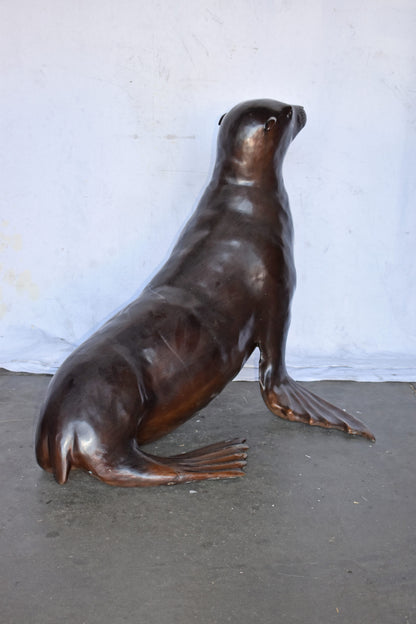 Perched Life Size Seal bronze statue - Size: 40"L x 35"W x 31"H.