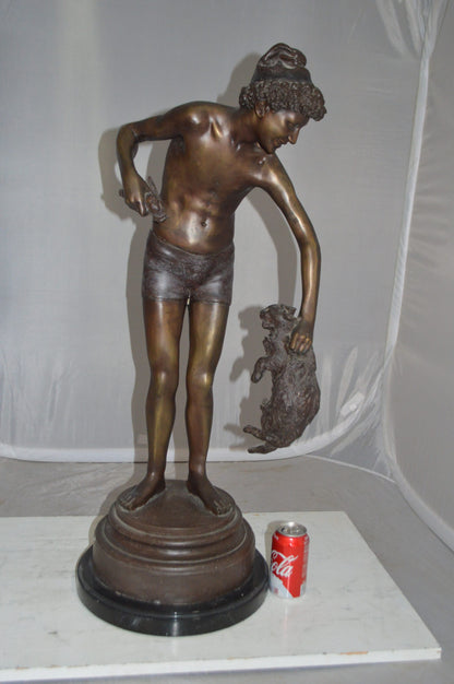 Boy holding a Dog and a Bird Bronze Statue -  Size: 15"L x 15"W x 36"H. 