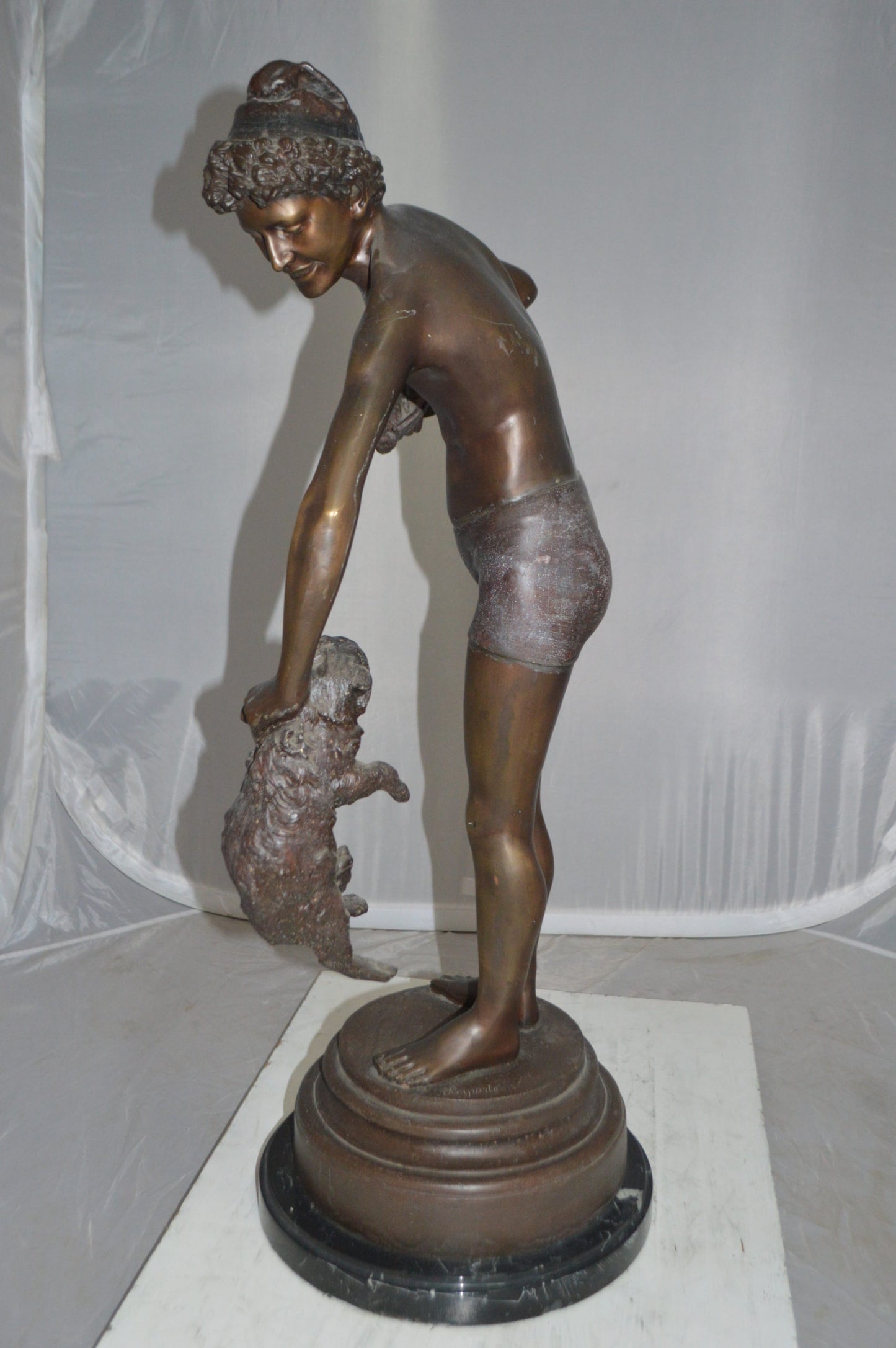 Boy holding a Dog and a Bird Bronze Statue -  Size: 15"L x 15"W x 36"H. 
