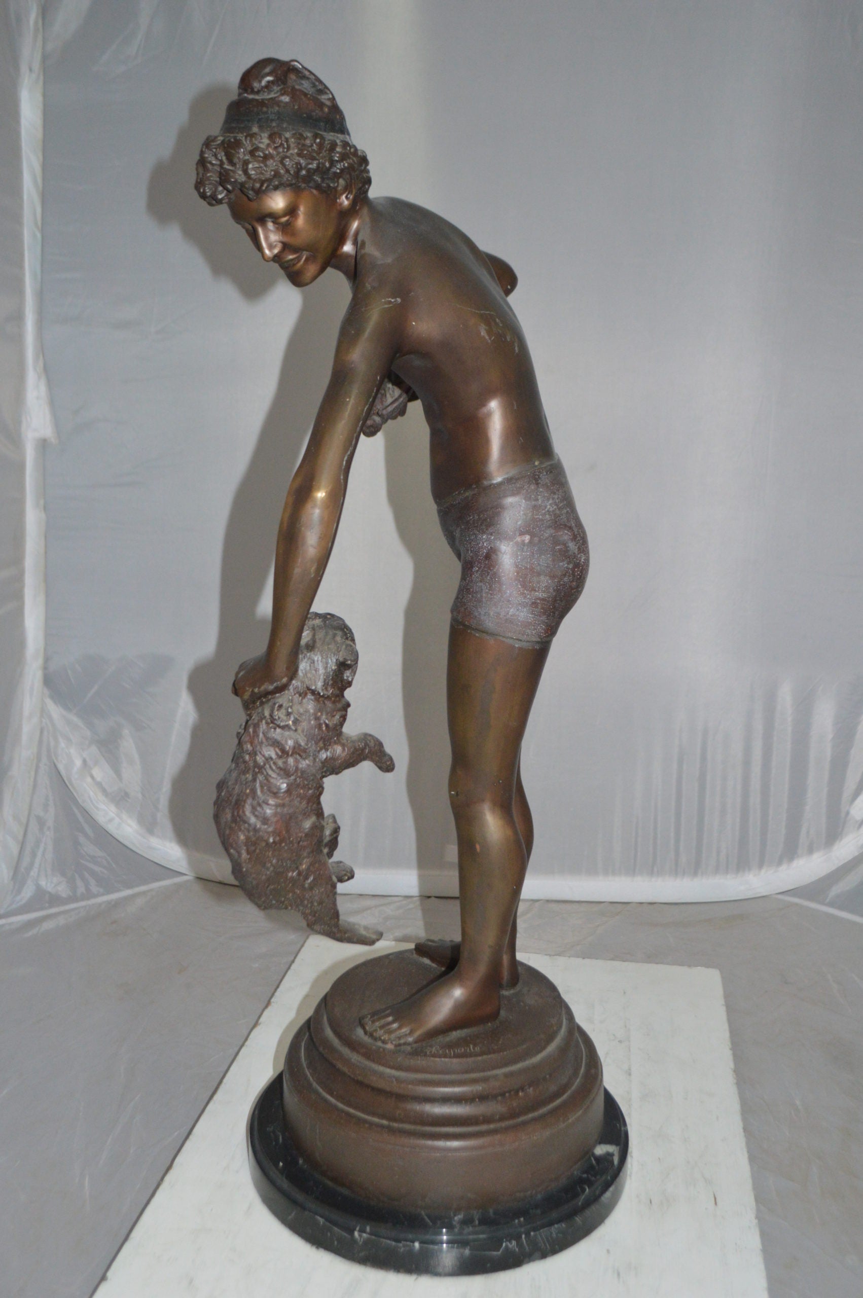 Boy holding a Dog and a Bird Bronze Statue -  Size: 15"L x 15"W x 36"H. 