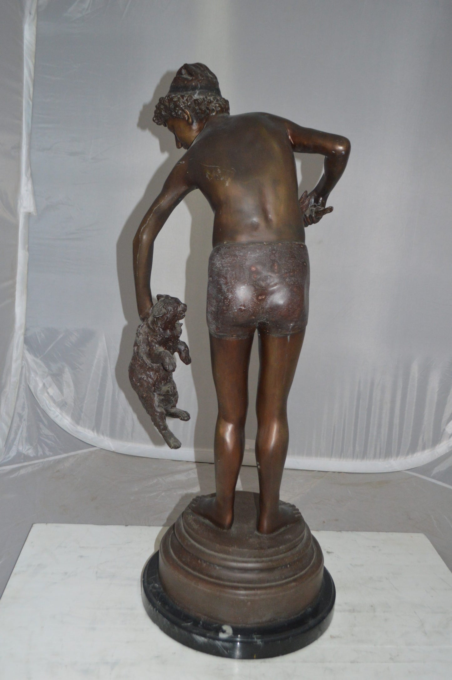 Boy holding a Dog and a Bird Bronze Statue -  Size: 15"L x 15"W x 36"H. 