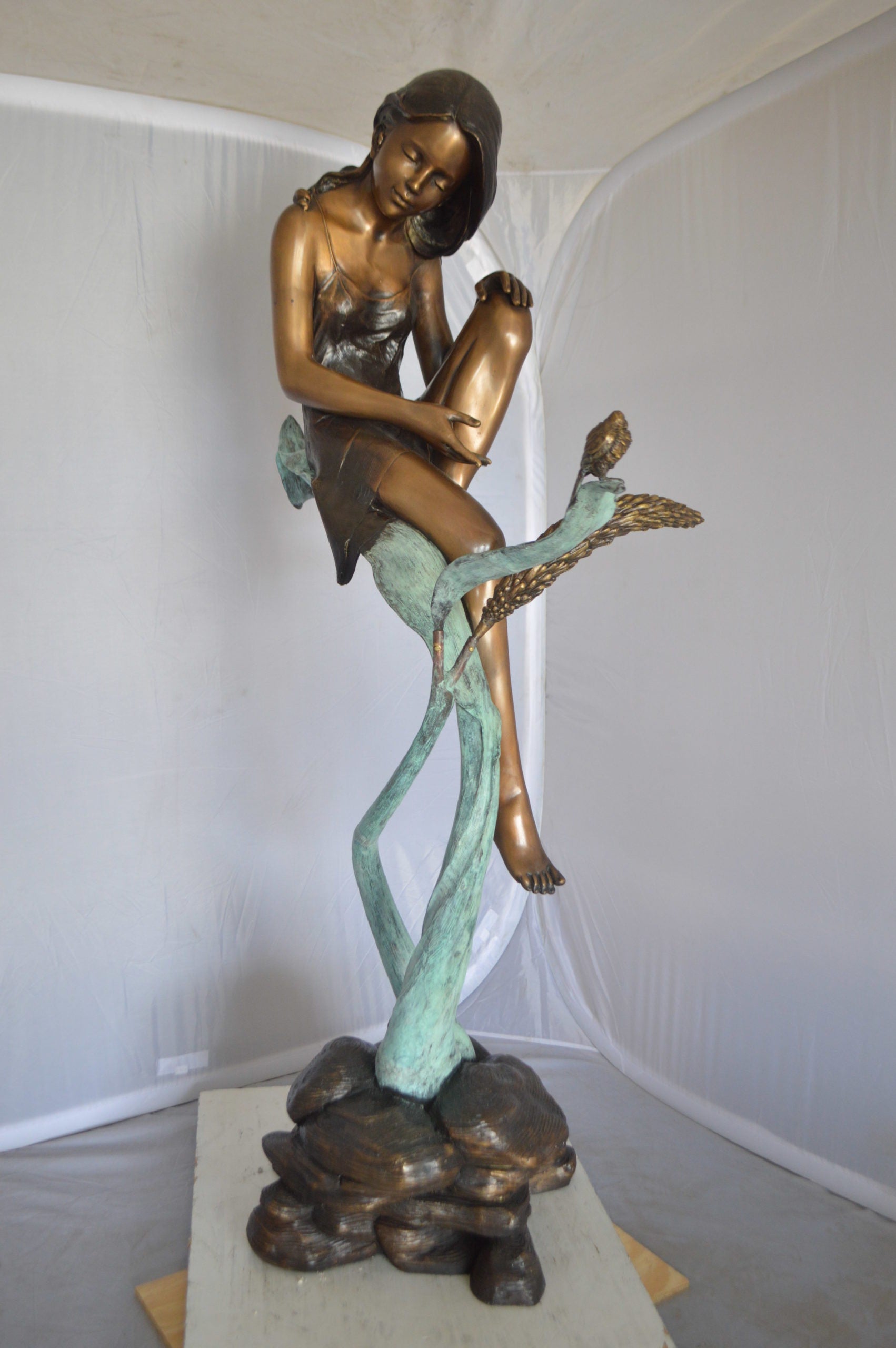Beautiful Young Girl Sitting on a Tree Bronze Statue -  35"L x 50"W x 55"H. 