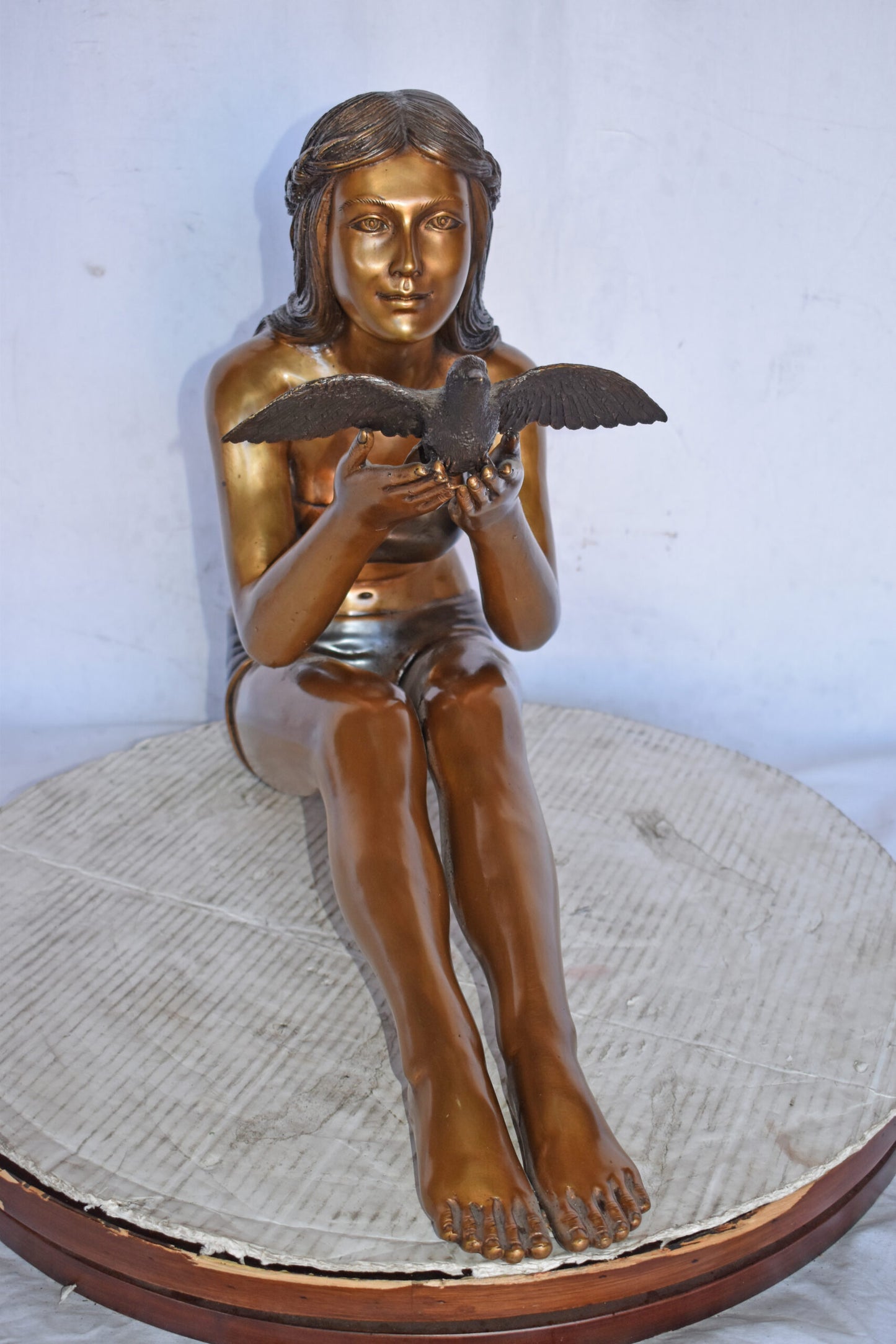 Young Beautiful Girl Helping A Bird Fly - Size: 22"L x 7"W x 18"H.