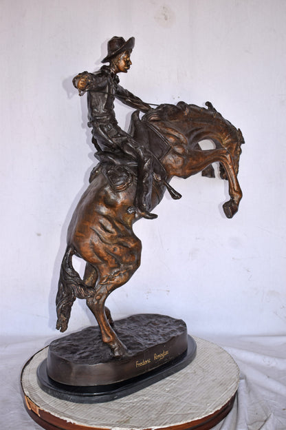 Bronco Buster by Remington Replica Bronze Statue - Size: 31"L x 17"W x 36"H.