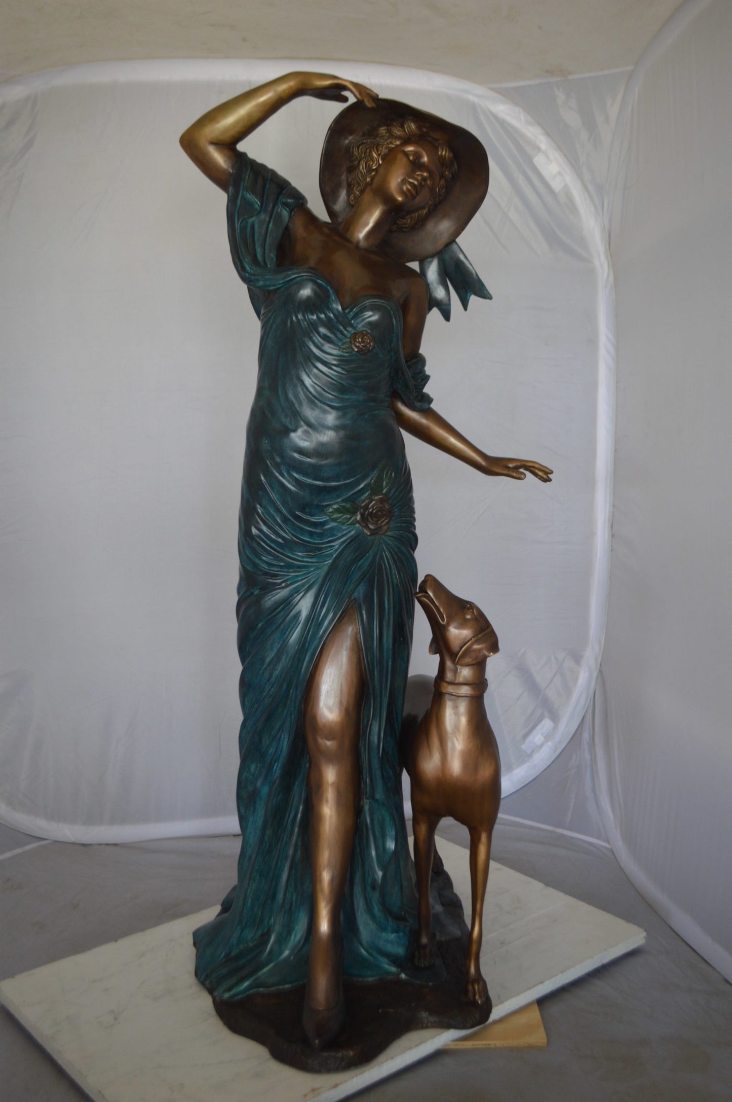 Lady With Her Dog Bronze Statue -  Size: 25"L x 22"W x 50"H. 
