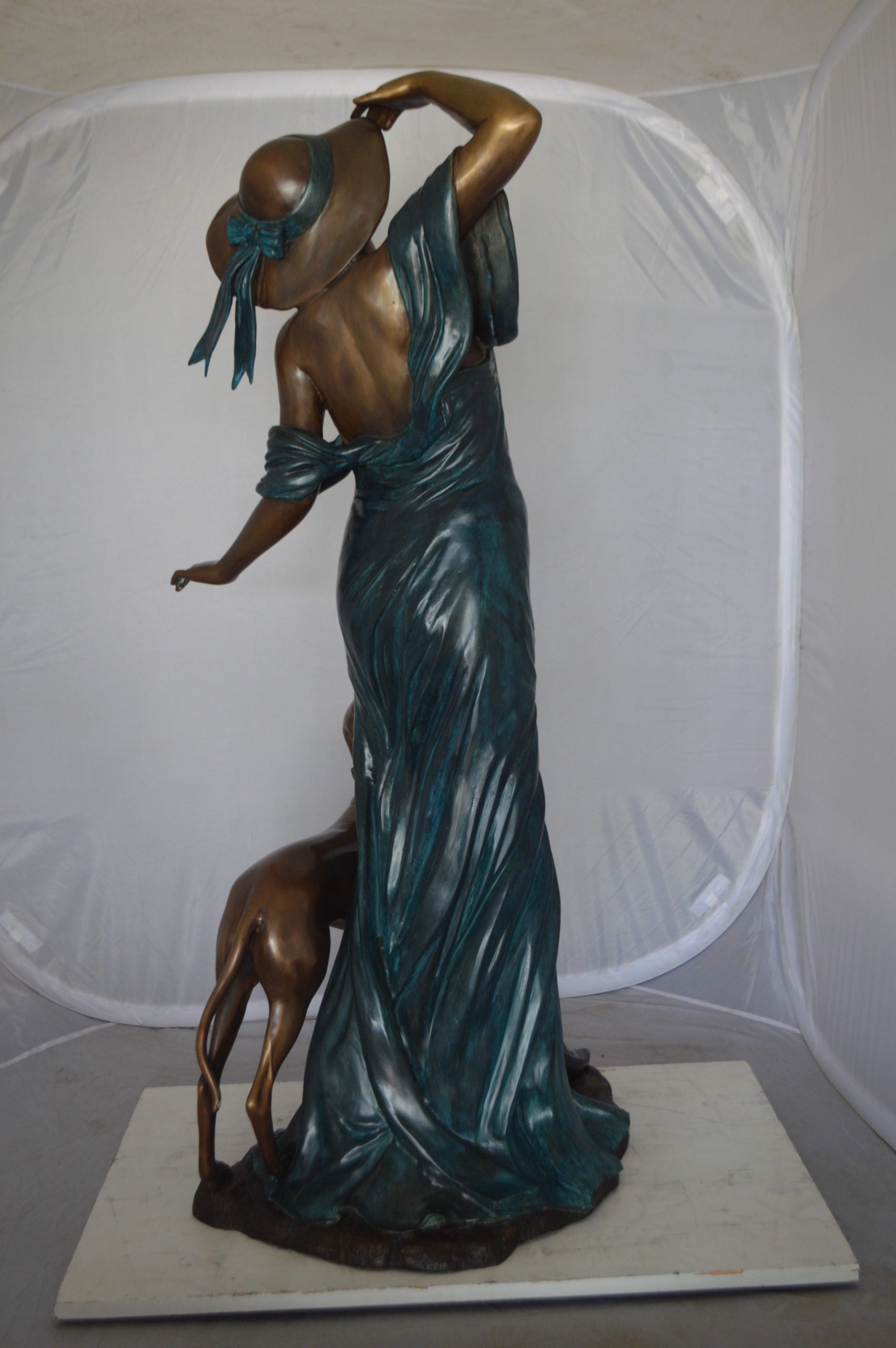Lady With Her Dog Bronze Statue -  Size: 25"L x 22"W x 50"H. 