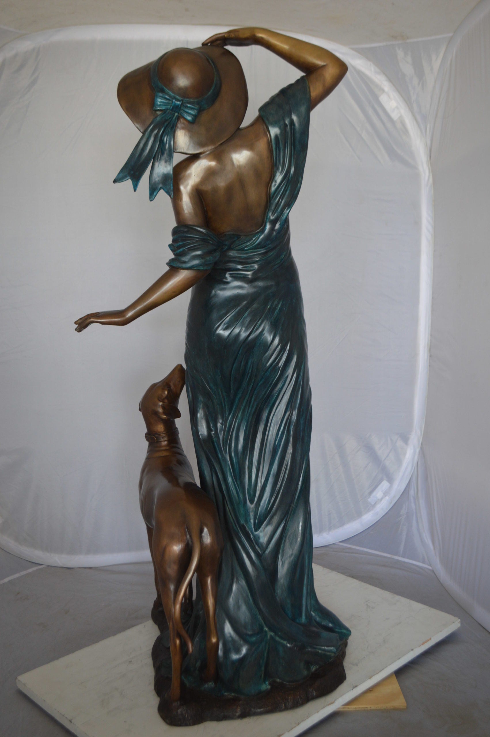 Lady With Her Dog Bronze Statue -  Size: 25"L x 22"W x 50"H. 