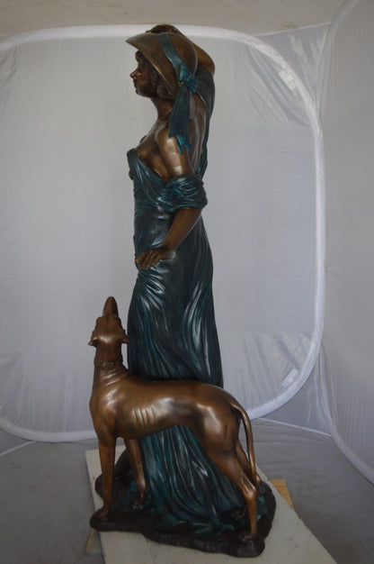 Lady With Her Dog Bronze Statue -  Size: 25"L x 22"W x 50"H. 