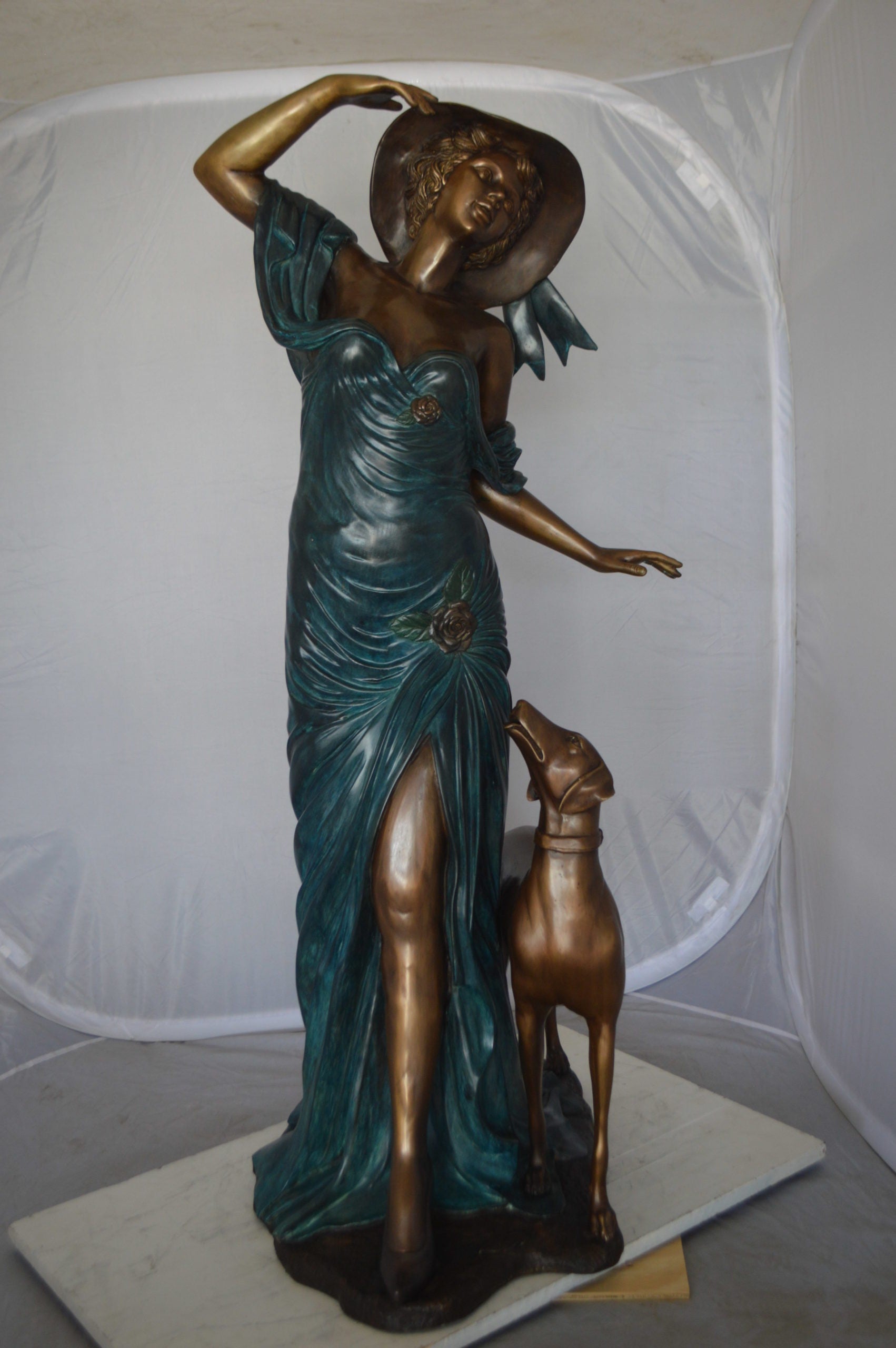 Lady With Her Dog Bronze Statue -  Size: 25"L x 22"W x 50"H. 