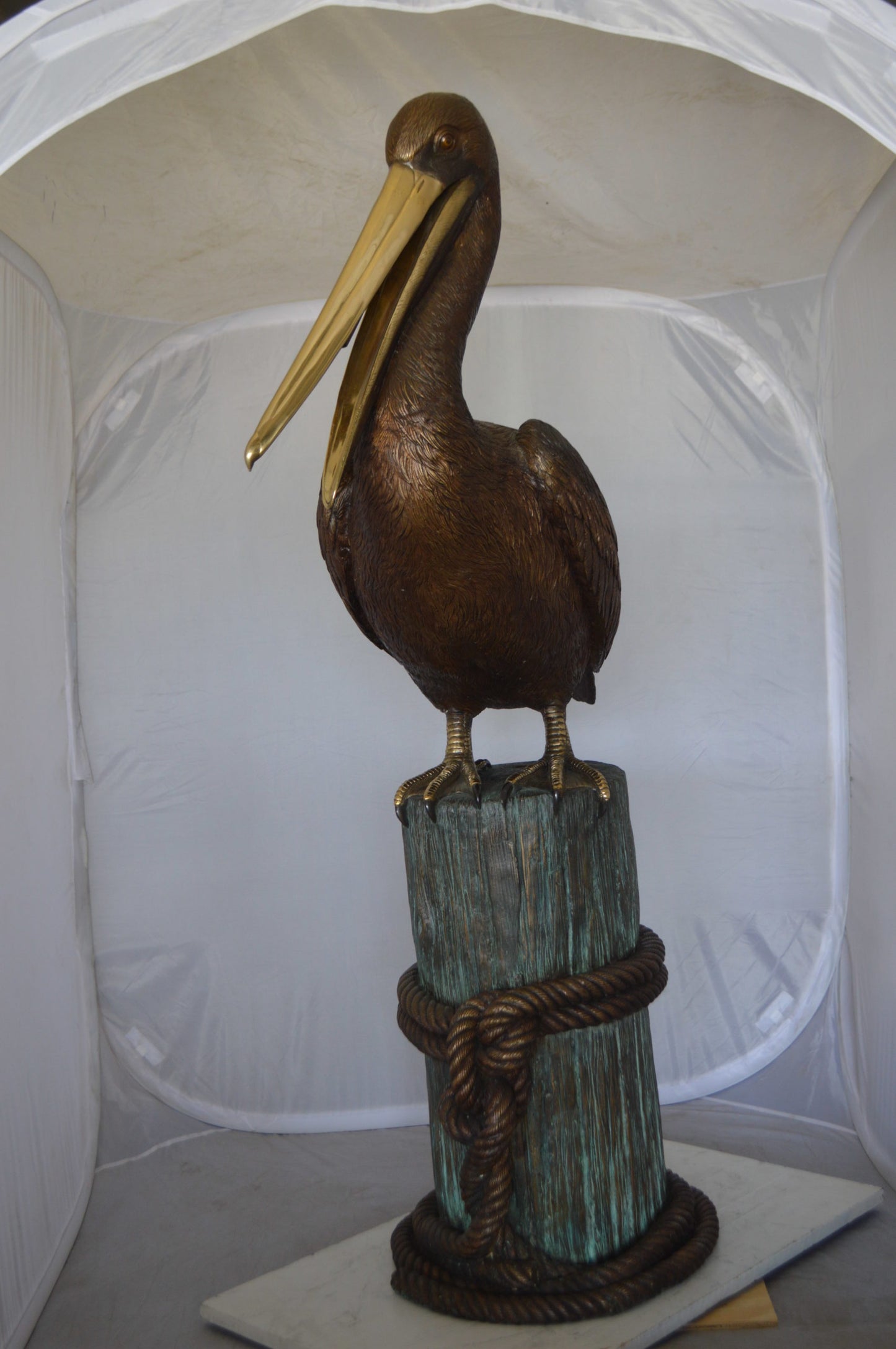Pelican on a Stump Bronze Statue -  Size: 14"L x 38"W x 58"H. 