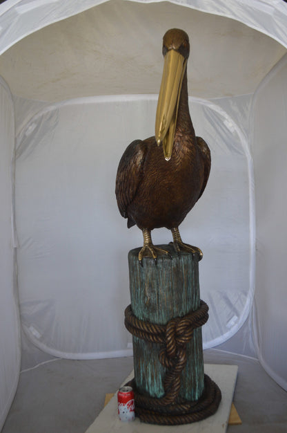Pelican on a Stump Bronze Statue -  Size: 14"L x 38"W x 58"H. 