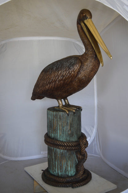 Pelican on a Stump Bronze Statue -  Size: 14"L x 38"W x 58"H. 