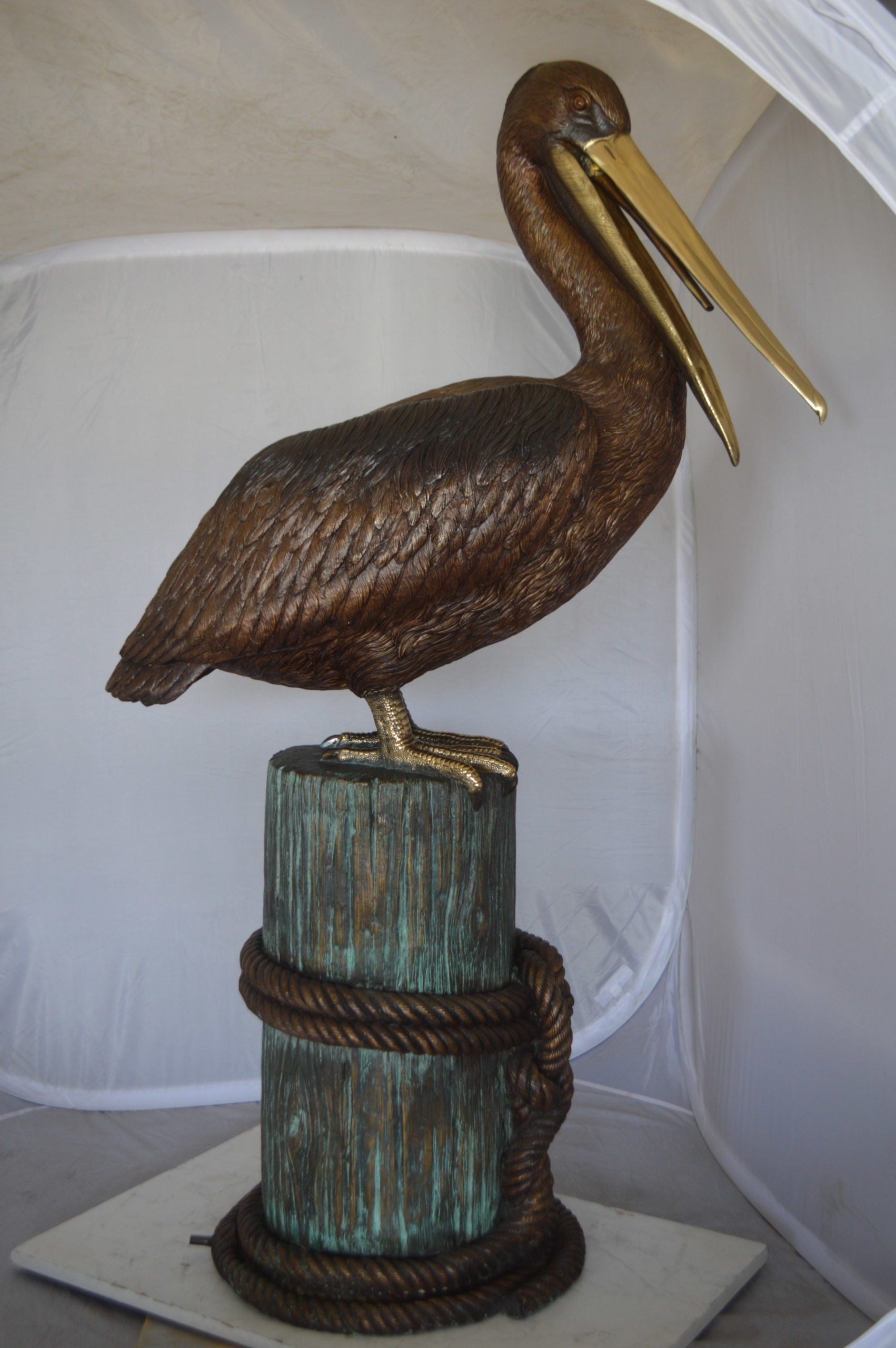 Pelican on a Stump Bronze Statue -  Size: 14"L x 38"W x 58"H. 