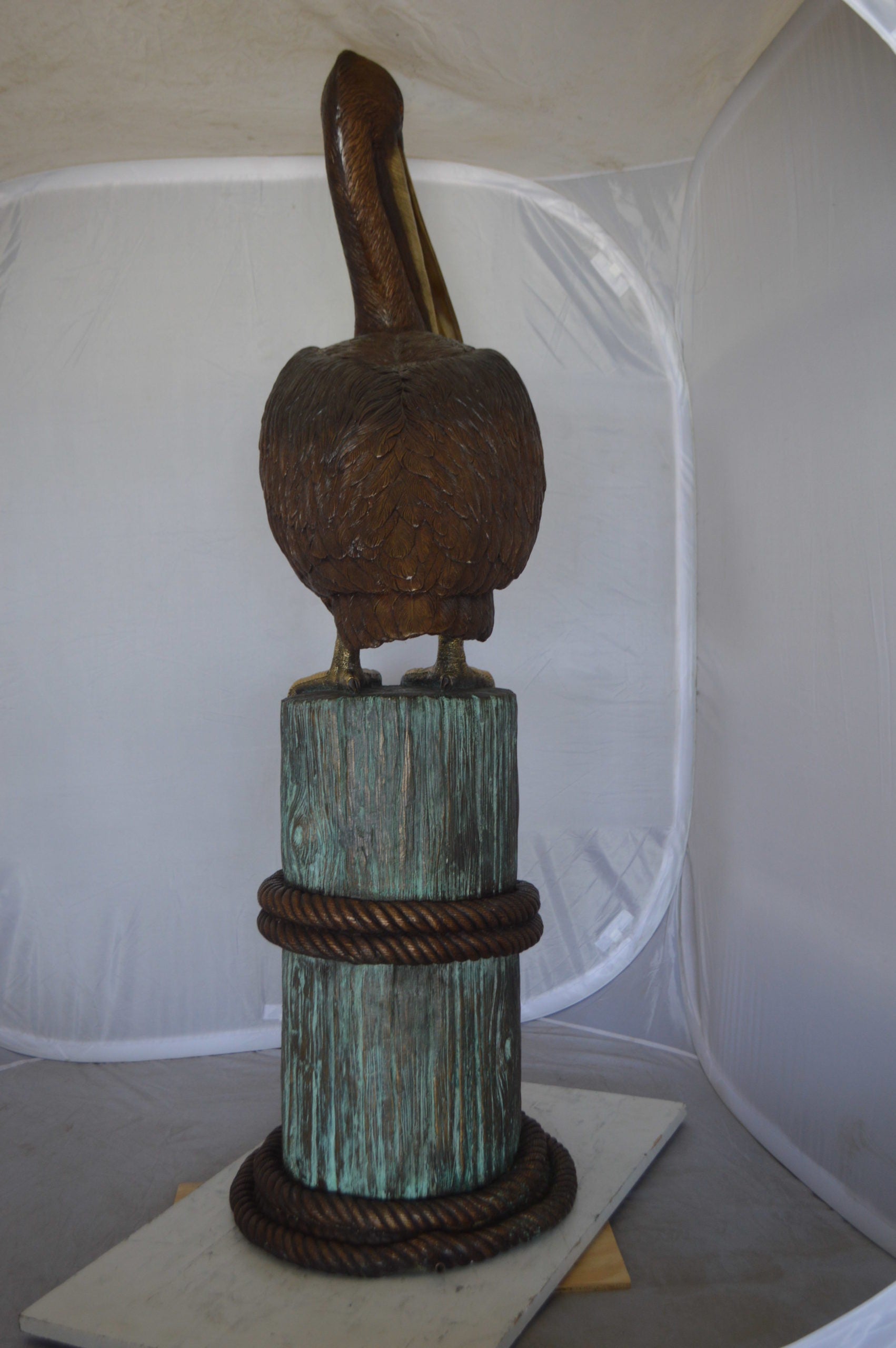 Pelican on a Stump Bronze Statue -  Size: 14"L x 38"W x 58"H. 