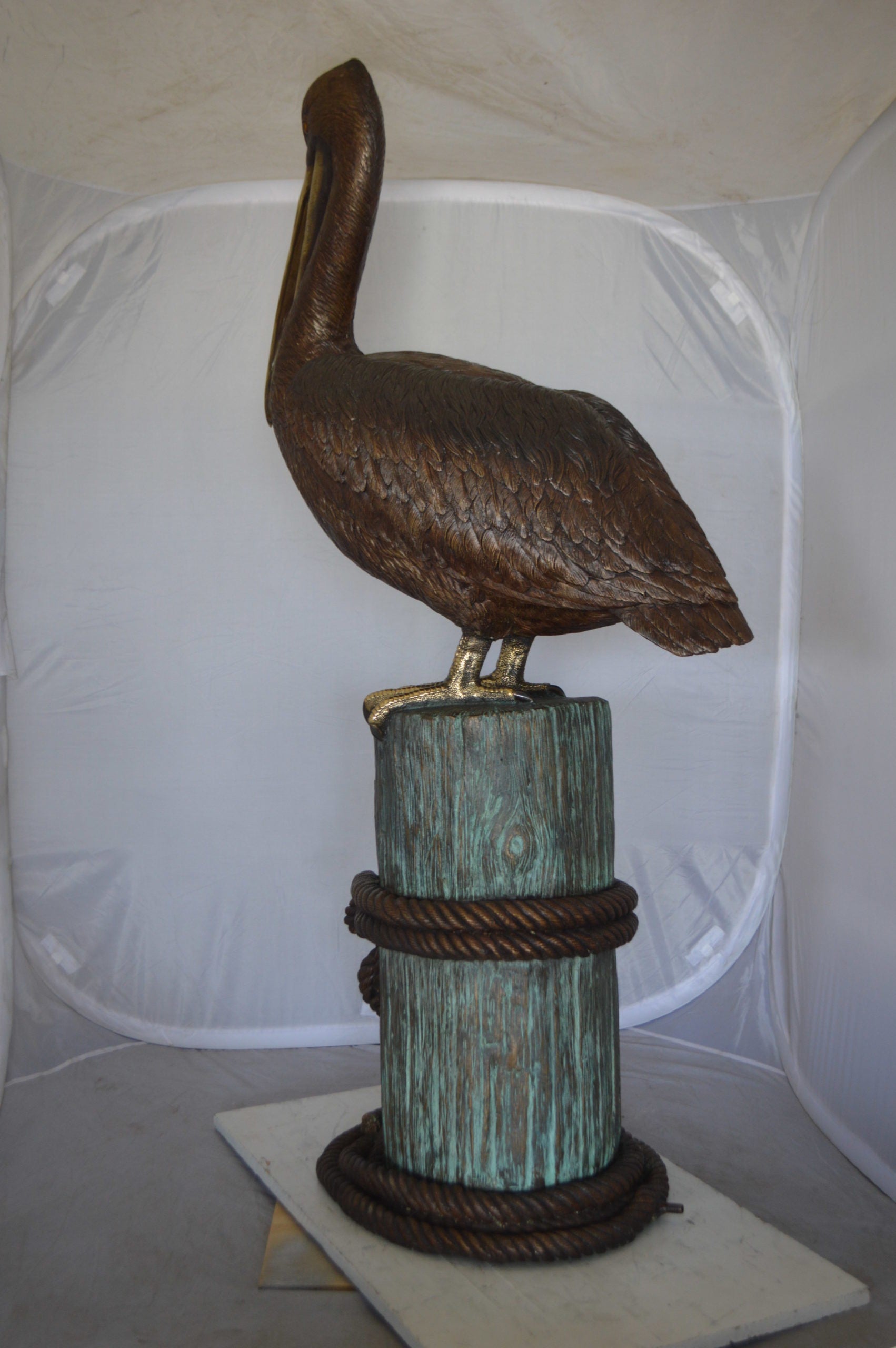 Pelican on a Stump Bronze Statue -  Size: 14"L x 38"W x 58"H. 