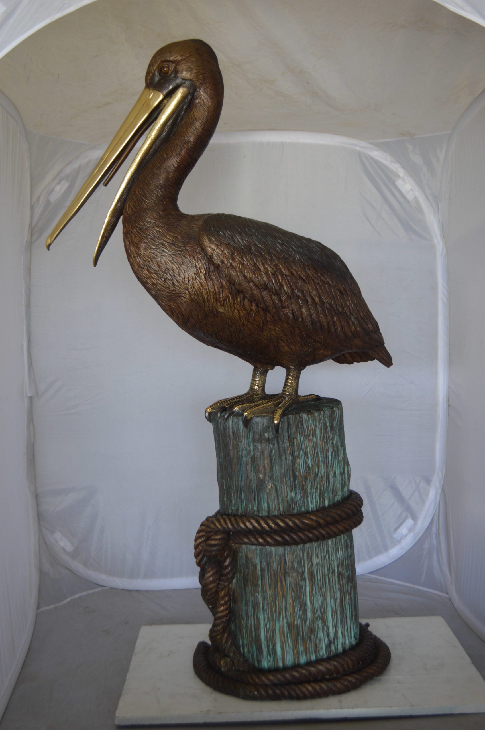 Pelican on a Stump Bronze Statue -  Size: 14"L x 38"W x 58"H. 