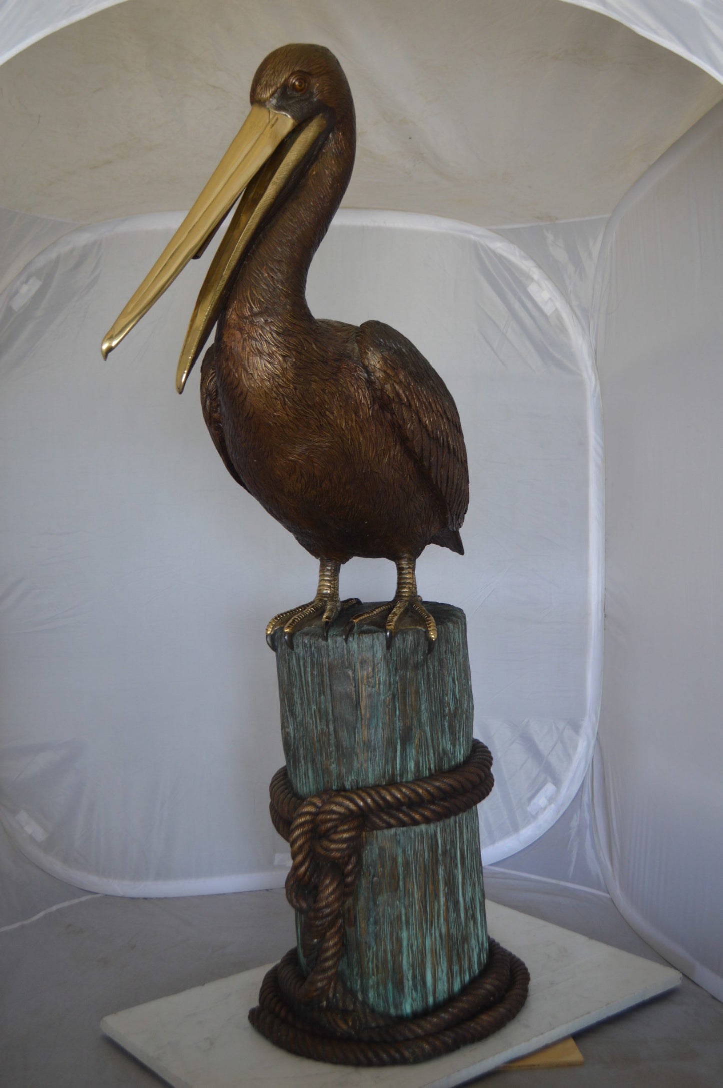 Pelican on a Stump Bronze Statue -  Size: 14"L x 38"W x 58"H. 