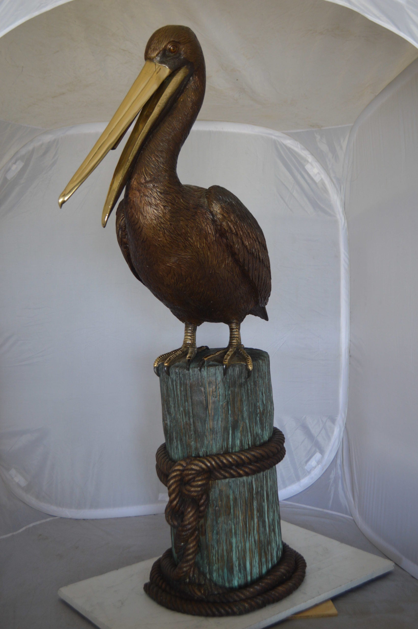 Pelican on a Stump Bronze Statue -  Size: 14"L x 38"W x 58"H. 