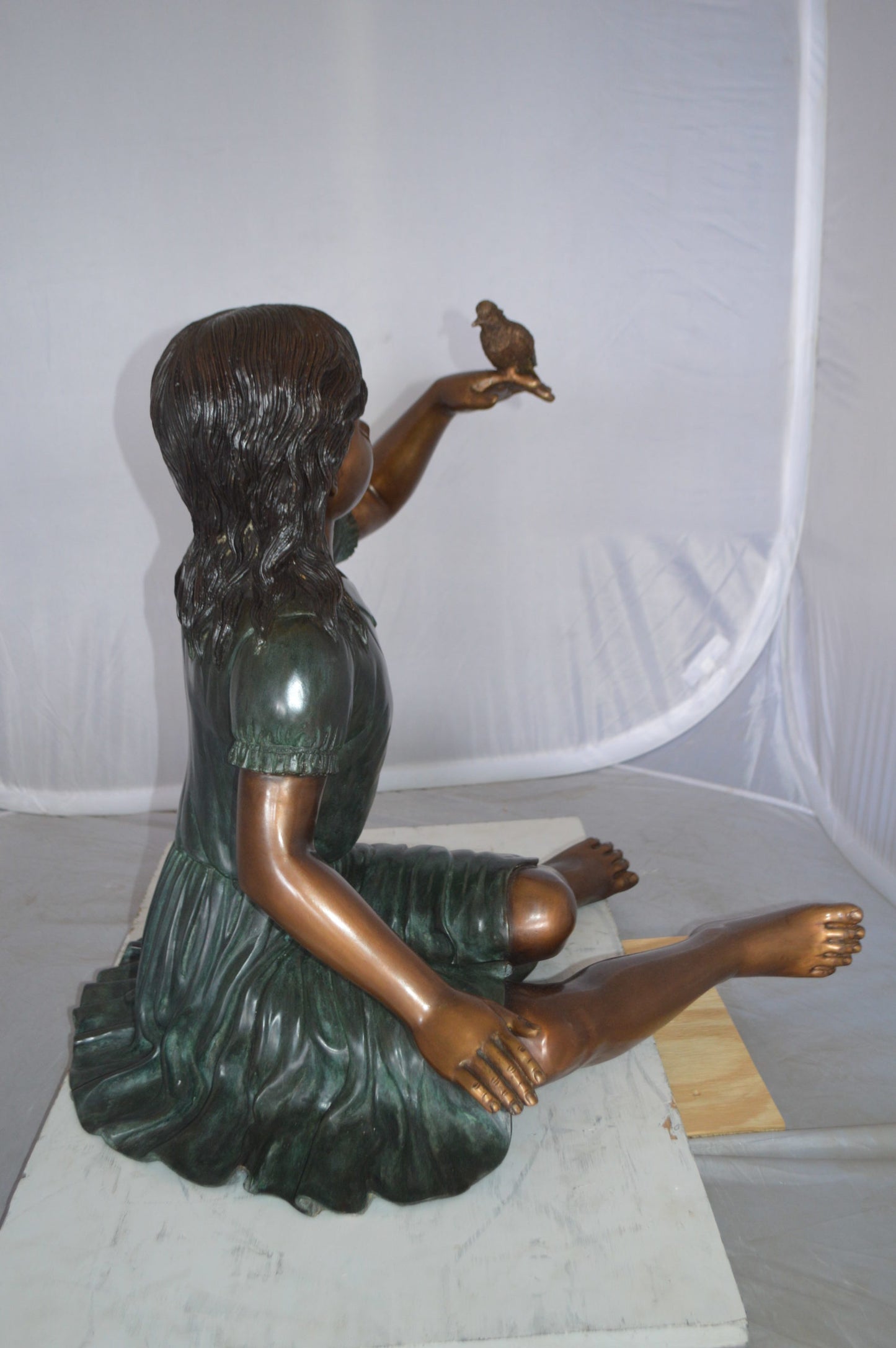 Girl with a Sparrow Bronze Statue -  Size: 24"L x 30"W x 25"H. 