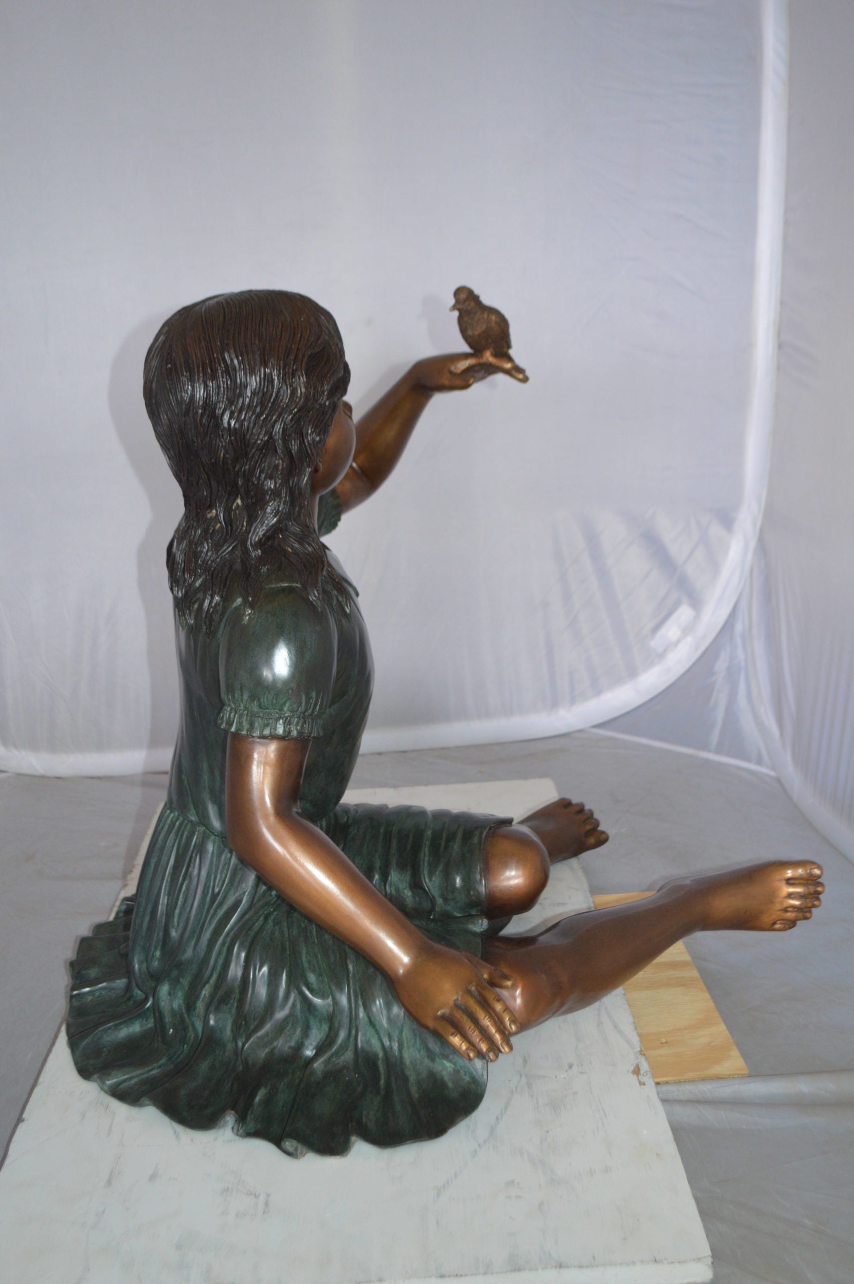 Girl with a Sparrow Bronze Statue -  Size: 24"L x 30"W x 25"H. 