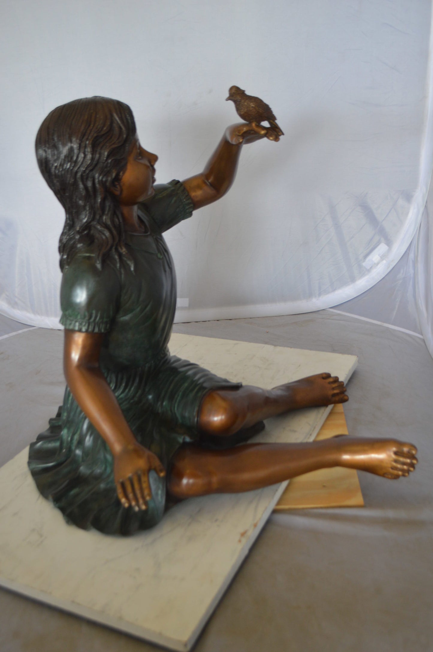 Girl with a Sparrow Bronze Statue -  Size: 24"L x 30"W x 25"H. 