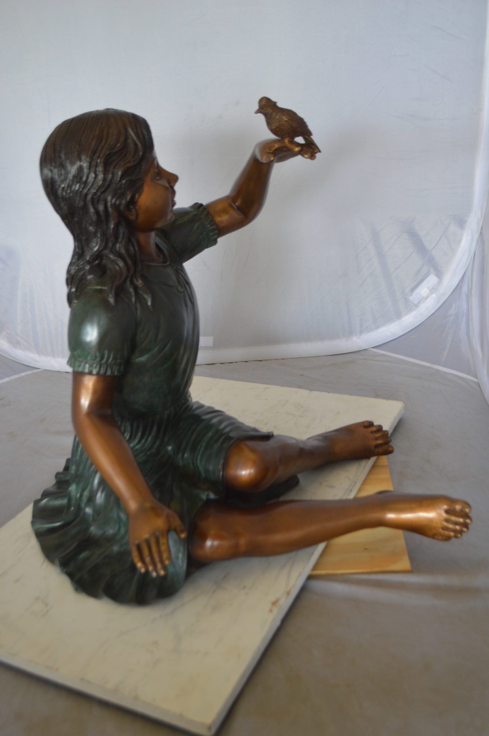 Girl with a Sparrow Bronze Statue -  Size: 24"L x 30"W x 25"H. 