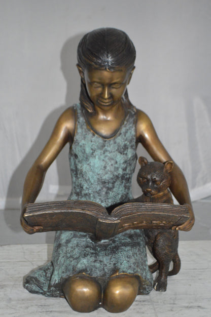 Girl and her dog reading a book Bronze Statue -  Size: 20"L x 8"W x 14"H.