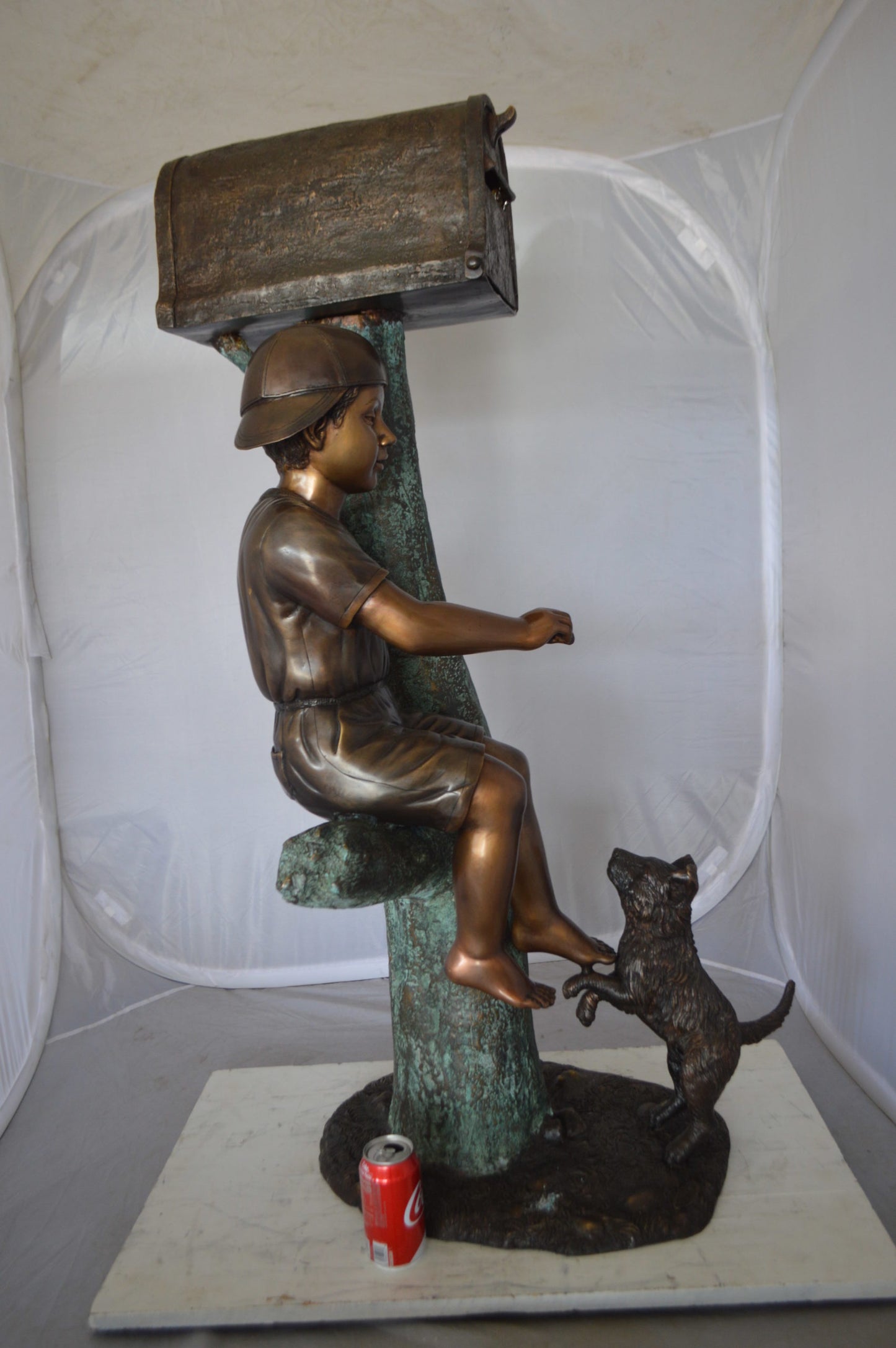 Boy Sitting on a Tree with Mailbox Bronze Statue -  Size: 22"L x 23"W x 49"H. 