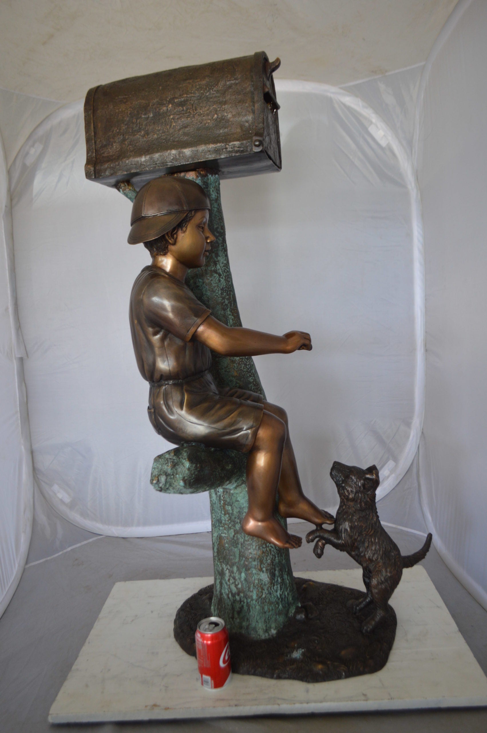 Boy Sitting on a Tree with Mailbox Bronze Statue -  Size: 22"L x 23"W x 49"H. 