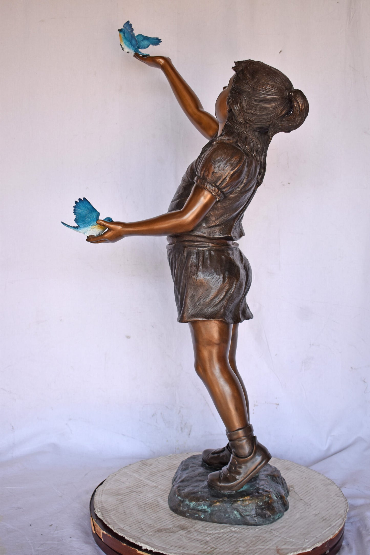 Girl, sandy, with two Blue birds Bronze Statue - Size: 25"L x 23"W x 41"H.