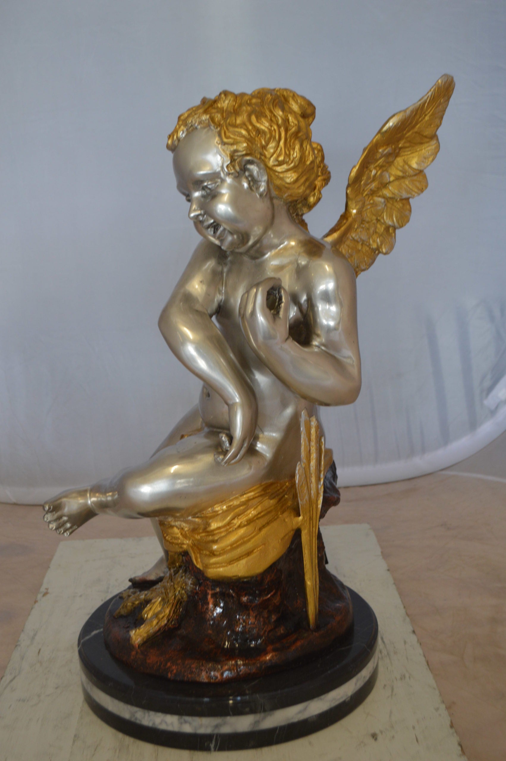 Cupid Girl On A Rock Bronze Statue  -  Size: 20"L x 15"W x 25"H. 