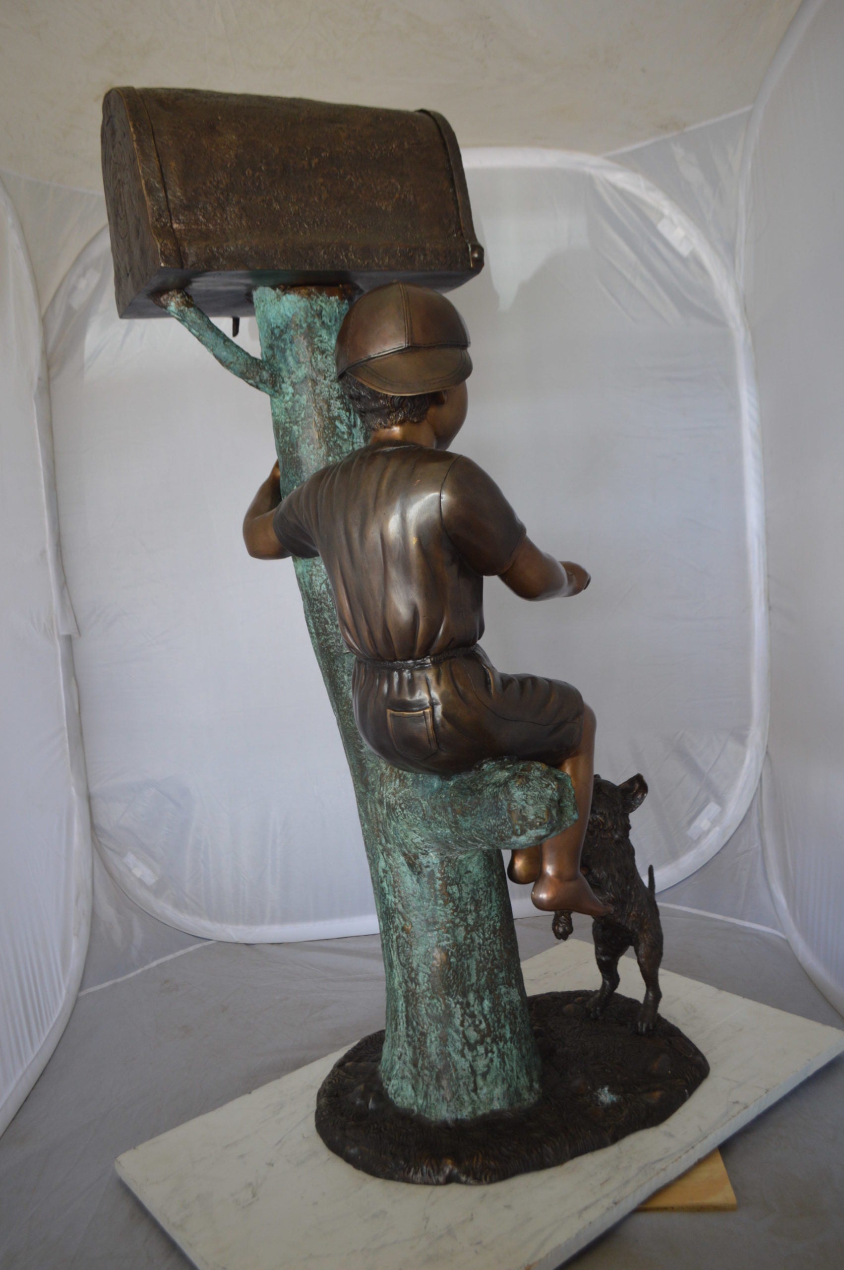 Boy Sitting on a Tree with Mailbox Bronze Statue -  Size: 22"L x 23"W x 49"H. 