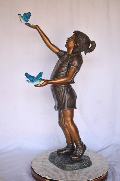 Girl, sandy, with two Blue birds Bronze Statue - Size: 25"L x 23"W x 41"H.