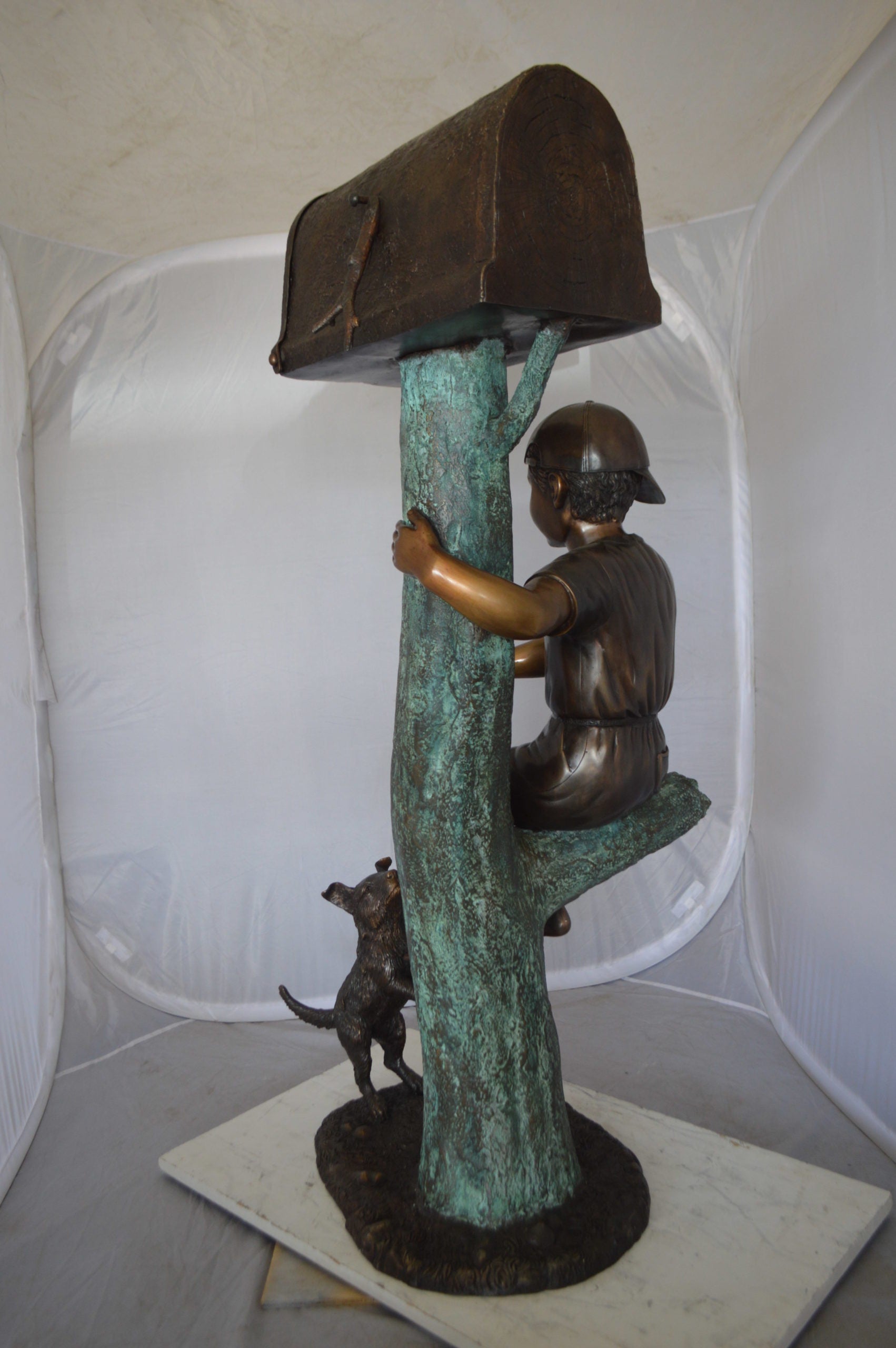 Boy Sitting on a Tree with Mailbox Bronze Statue -  Size: 22"L x 23"W x 49"H. 