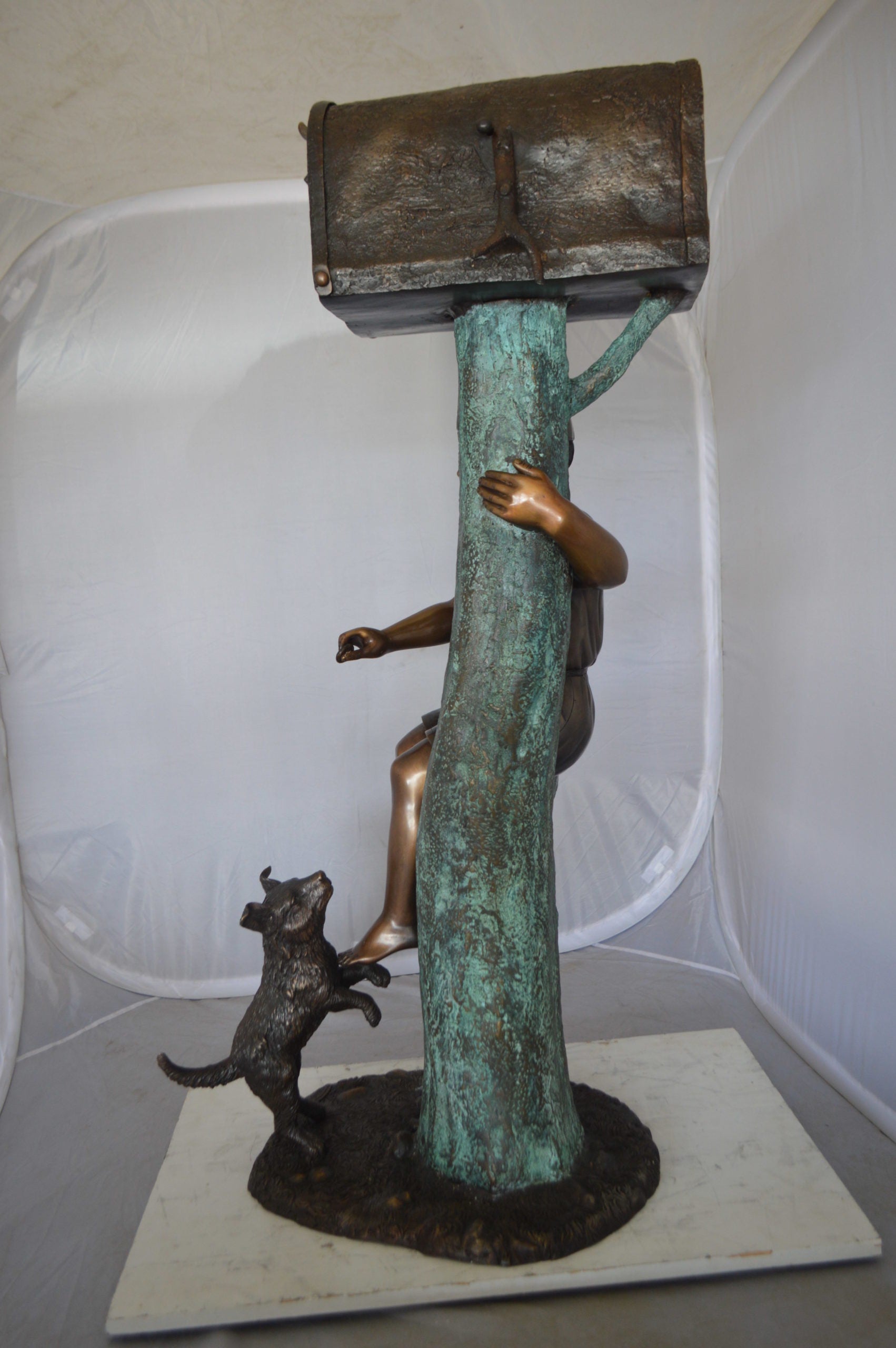 Boy Sitting on a Tree with Mailbox Bronze Statue -  Size: 22"L x 23"W x 49"H. 