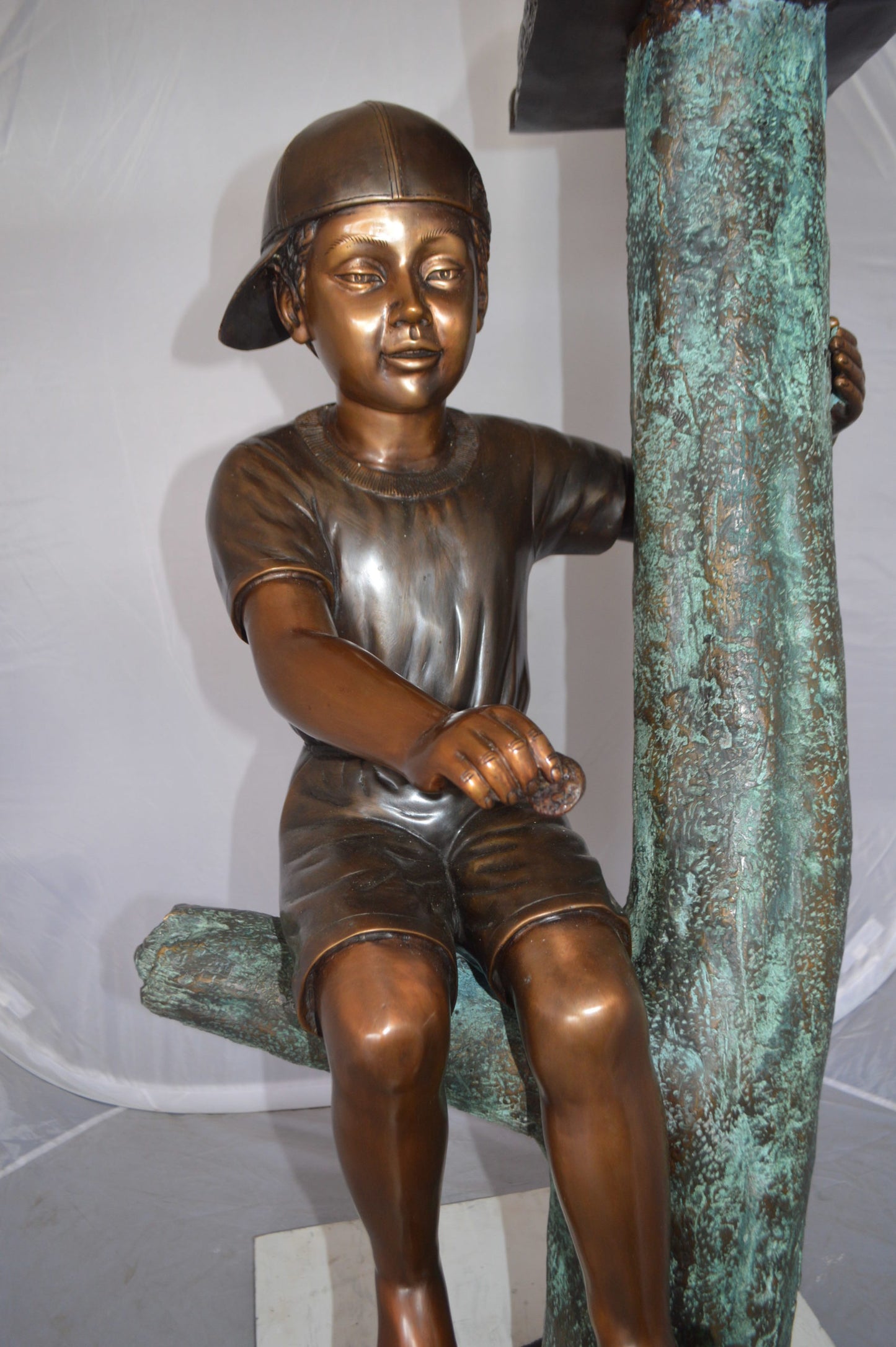 Boy Sitting on a Tree with Mailbox Bronze Statue -  Size: 22"L x 23"W x 49"H. 
