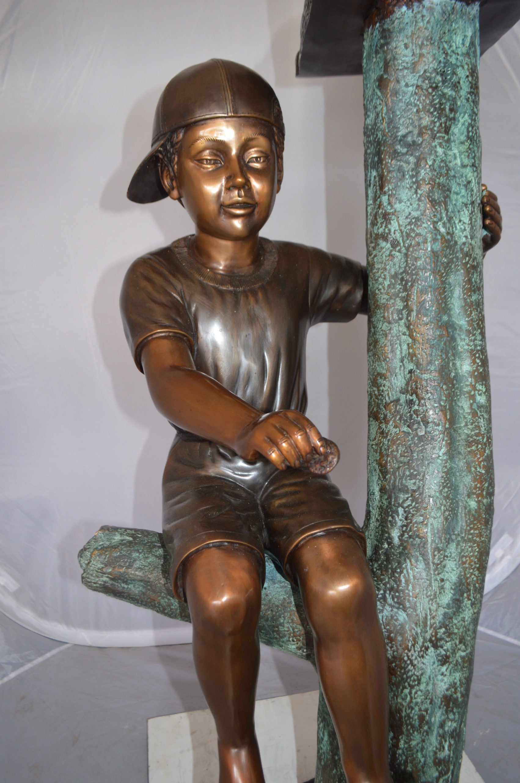 Boy Sitting on a Tree with Mailbox Bronze Statue -  Size: 22"L x 23"W x 49"H. 