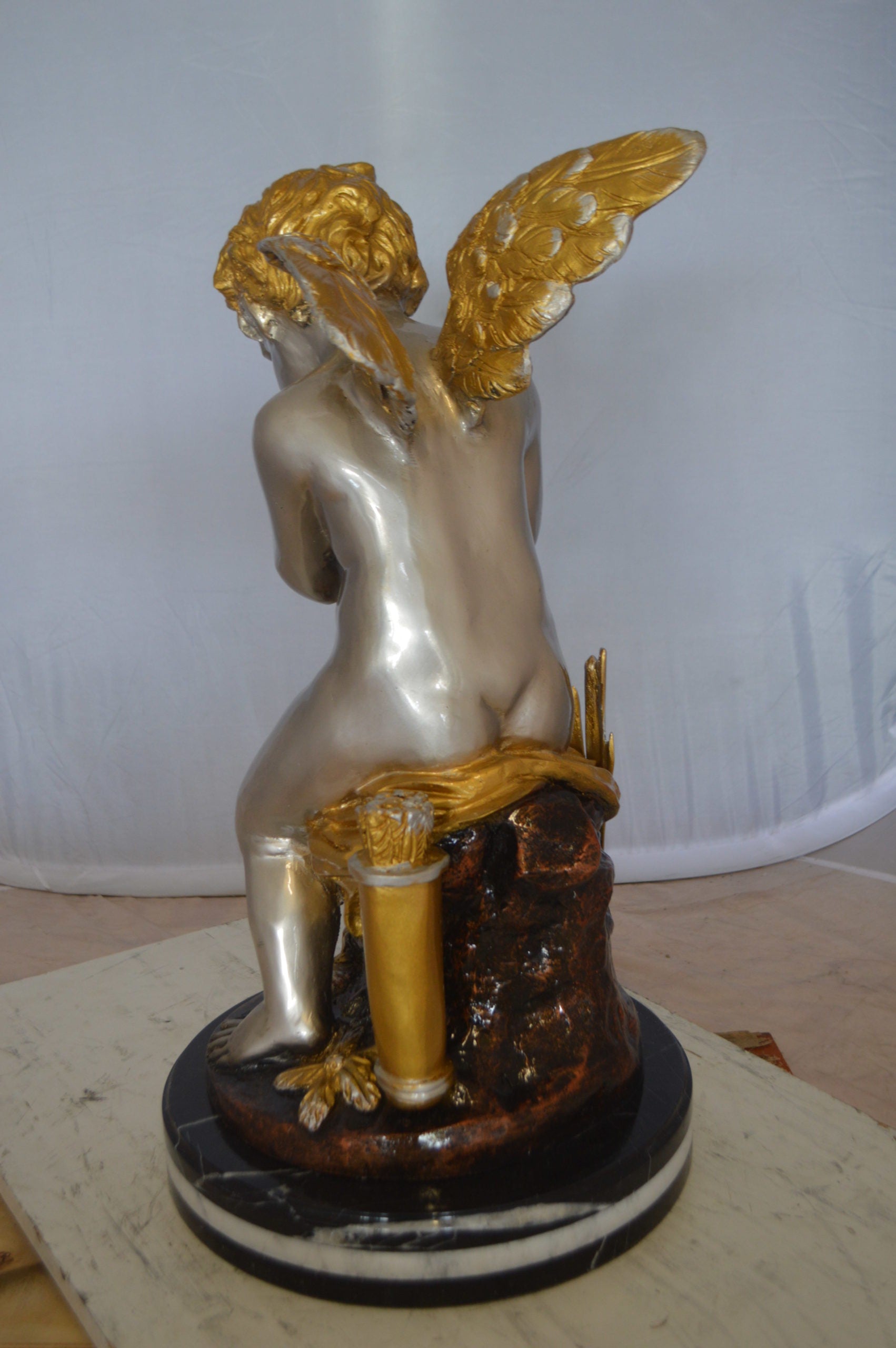 Cupid Boy On A Rock Bronze Statue  -  Size: 20"L x 15"W x 26"H. 