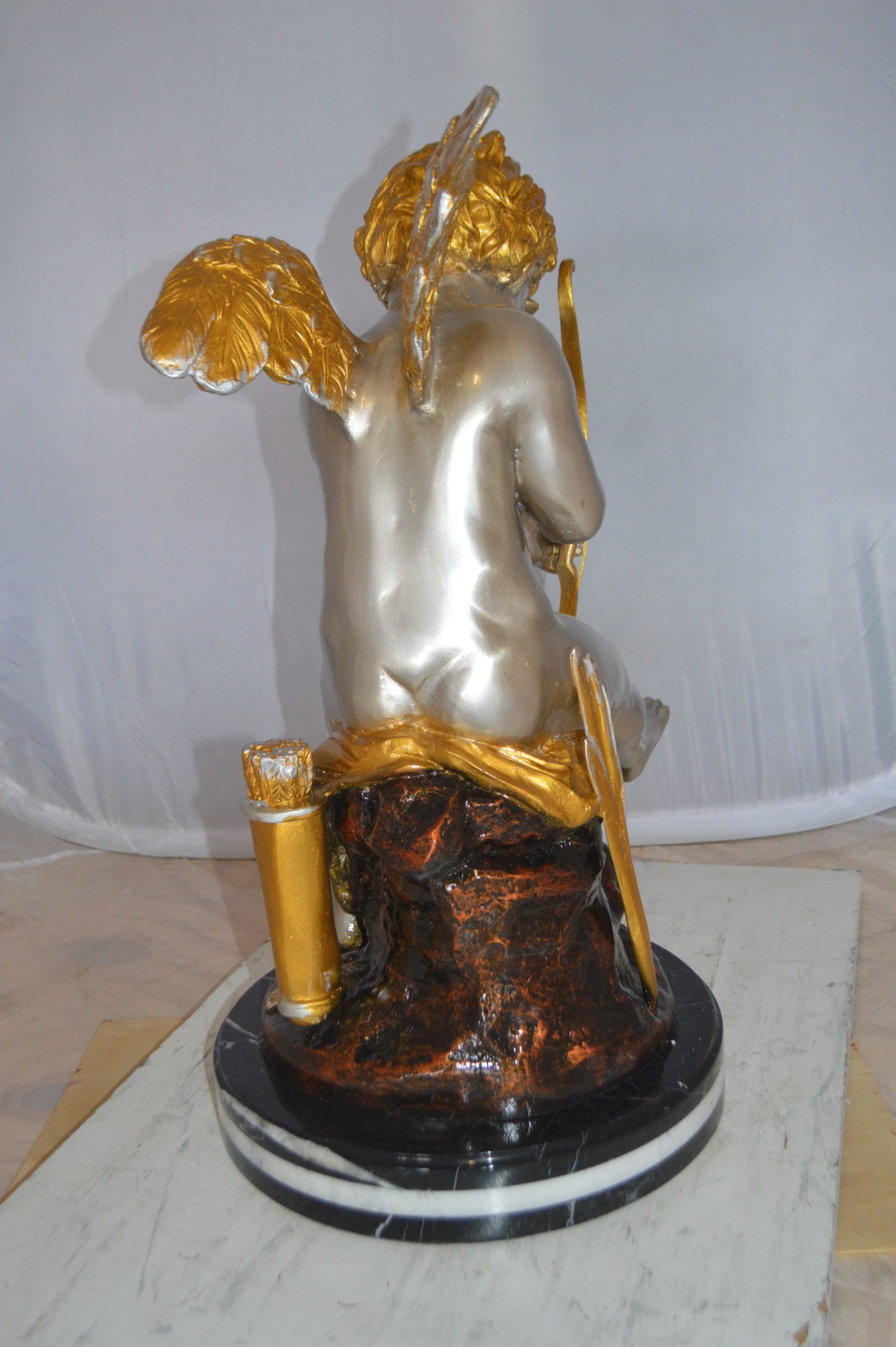 Cupid Boy On A Rock Bronze Statue  -  Size: 20"L x 15"W x 26"H. 