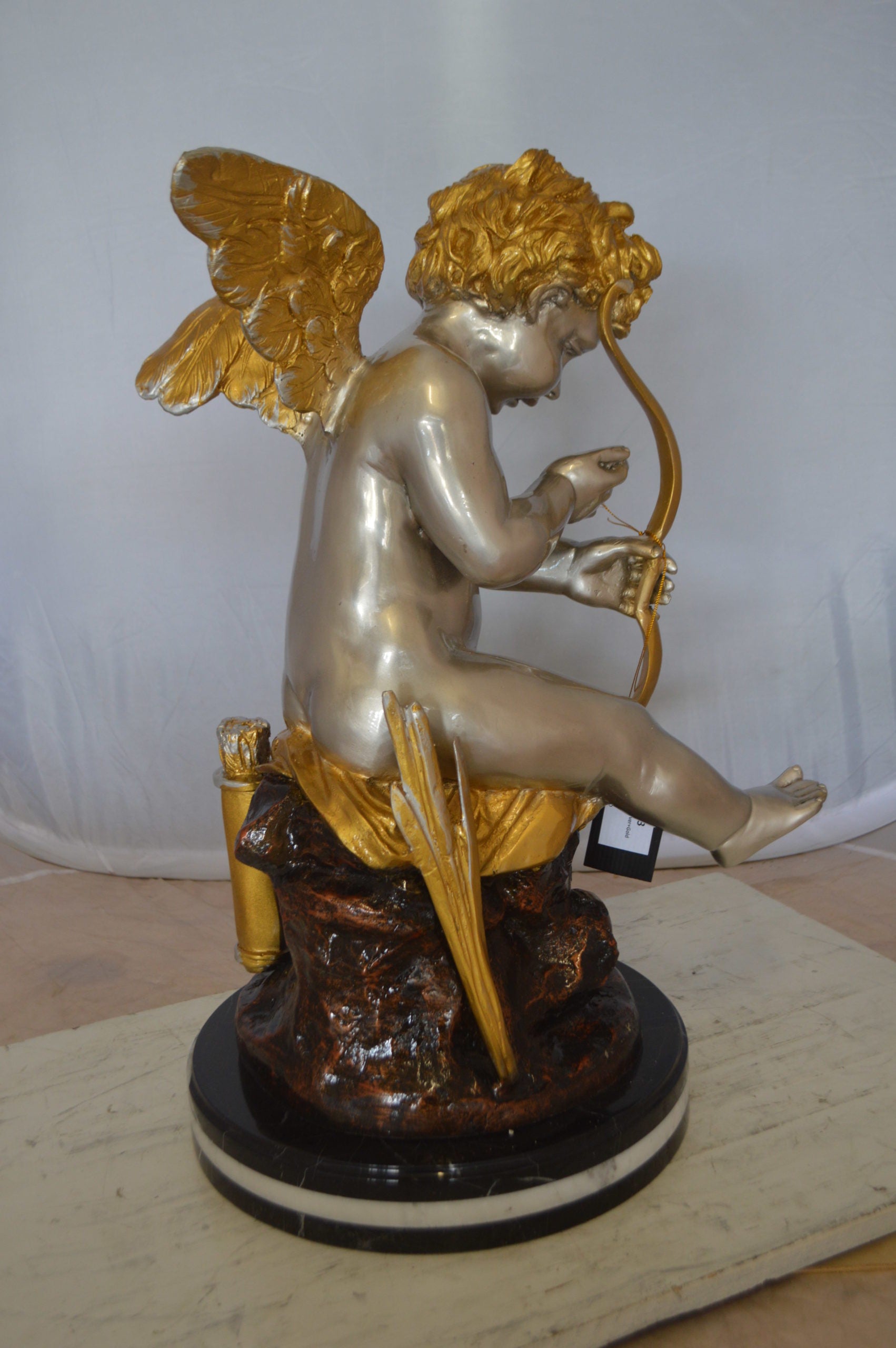Cupid Boy On A Rock Bronze Statue  -  Size: 20"L x 15"W x 26"H. 
