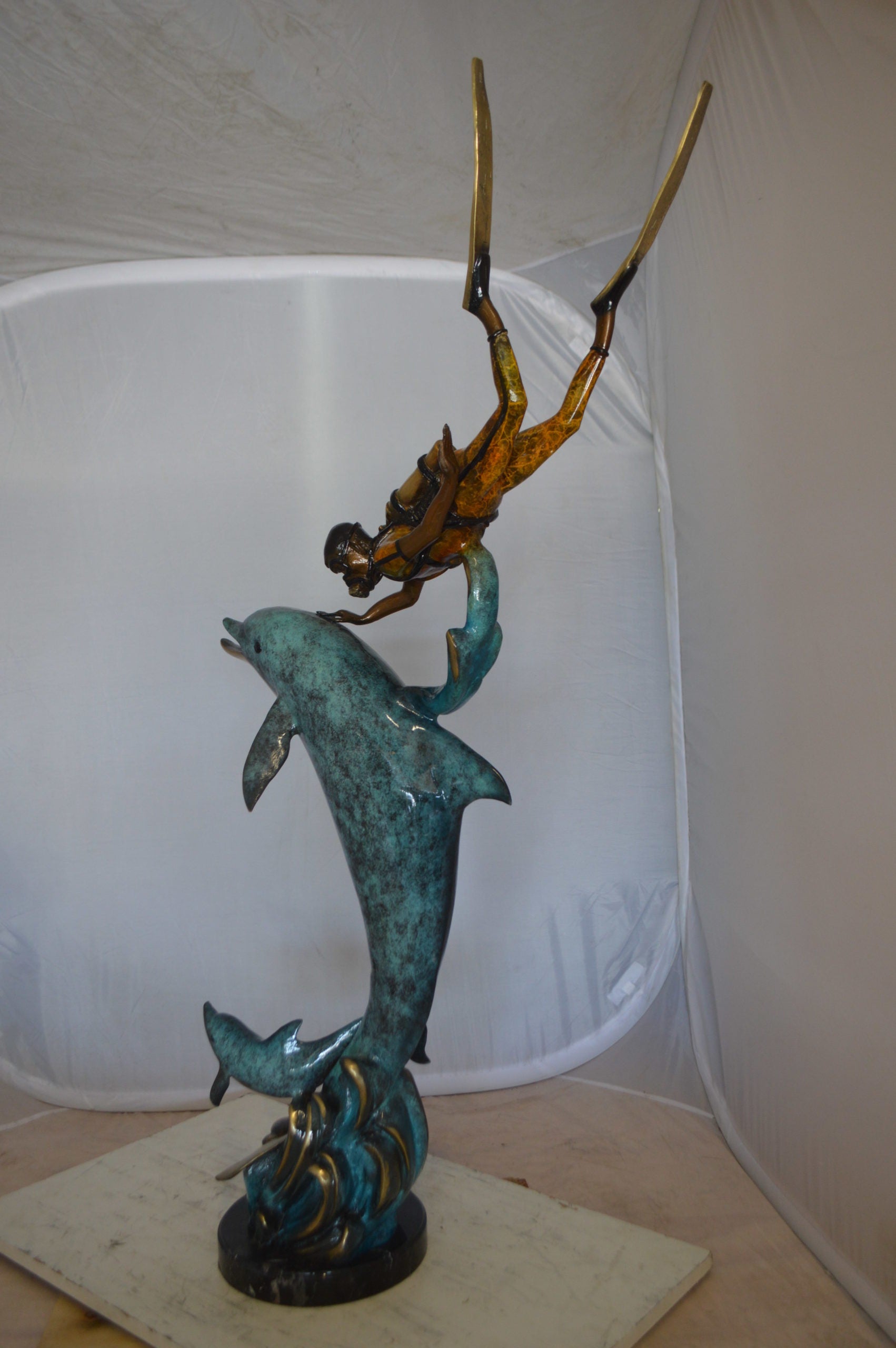 Diver With Dolphin Bronze Statue -  Size: 10"L x 30"W x 49"H. 