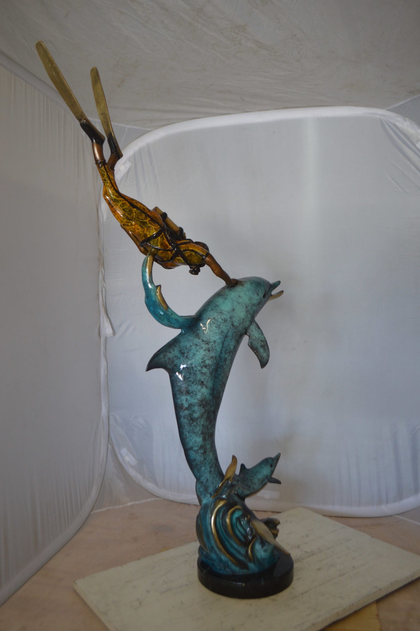 Diver With Dolphin Bronze Statue -  Size: 10"L x 30"W x 49"H. 