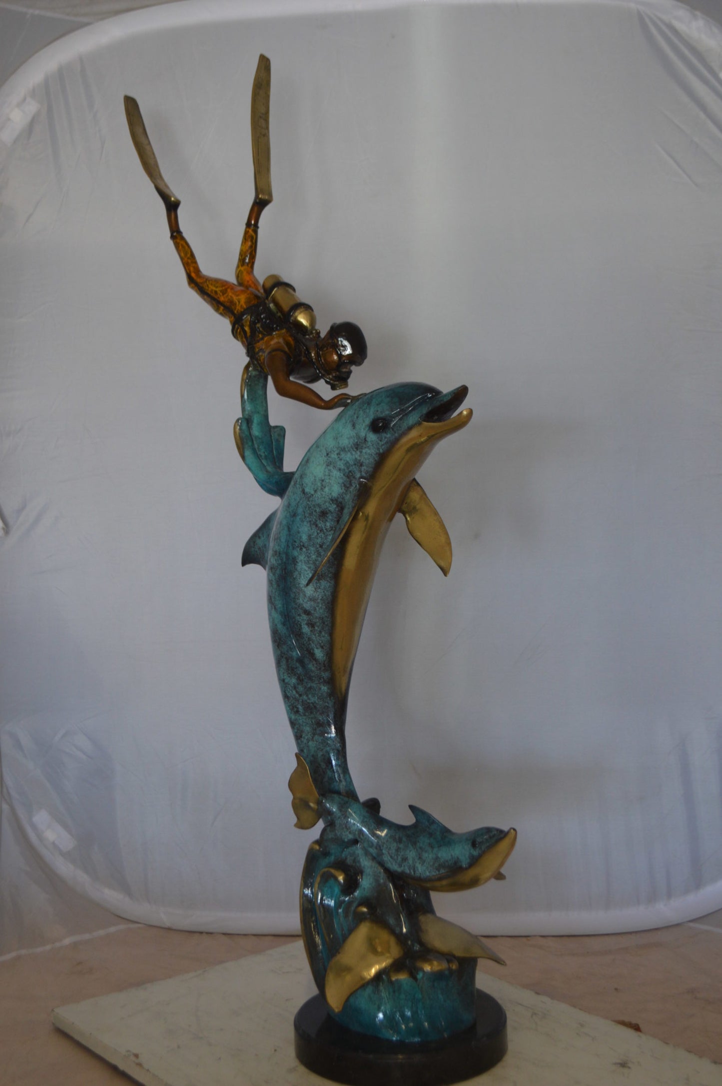 Diver With Dolphin Bronze Statue -  Size: 10"L x 30"W x 49"H. 