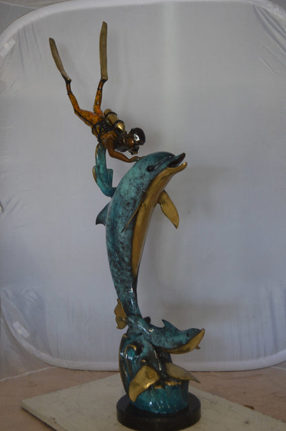 Diver With Dolphin Bronze Statue -  Size: 10"L x 30"W x 49"H. 