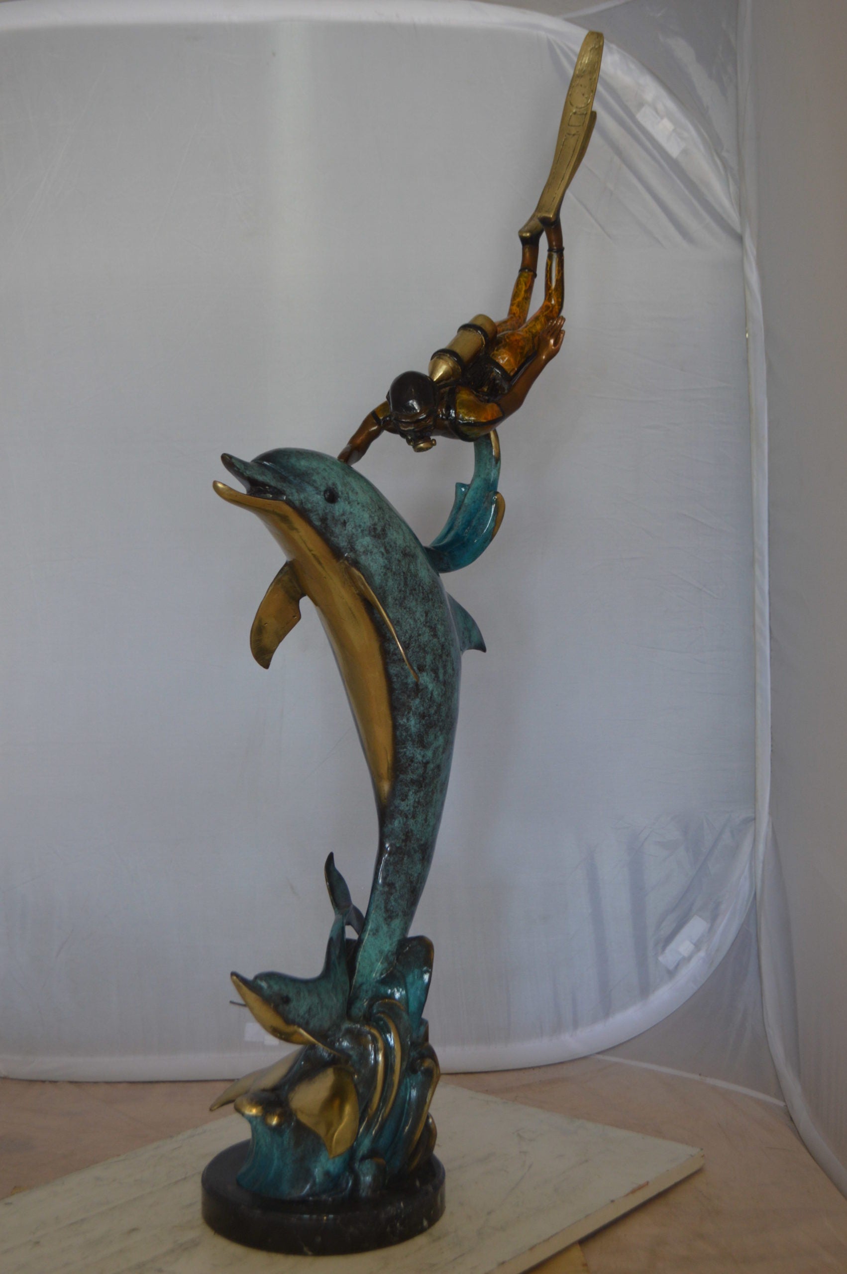 Diver With Dolphin Bronze Statue -  Size: 10"L x 30"W x 49"H. 