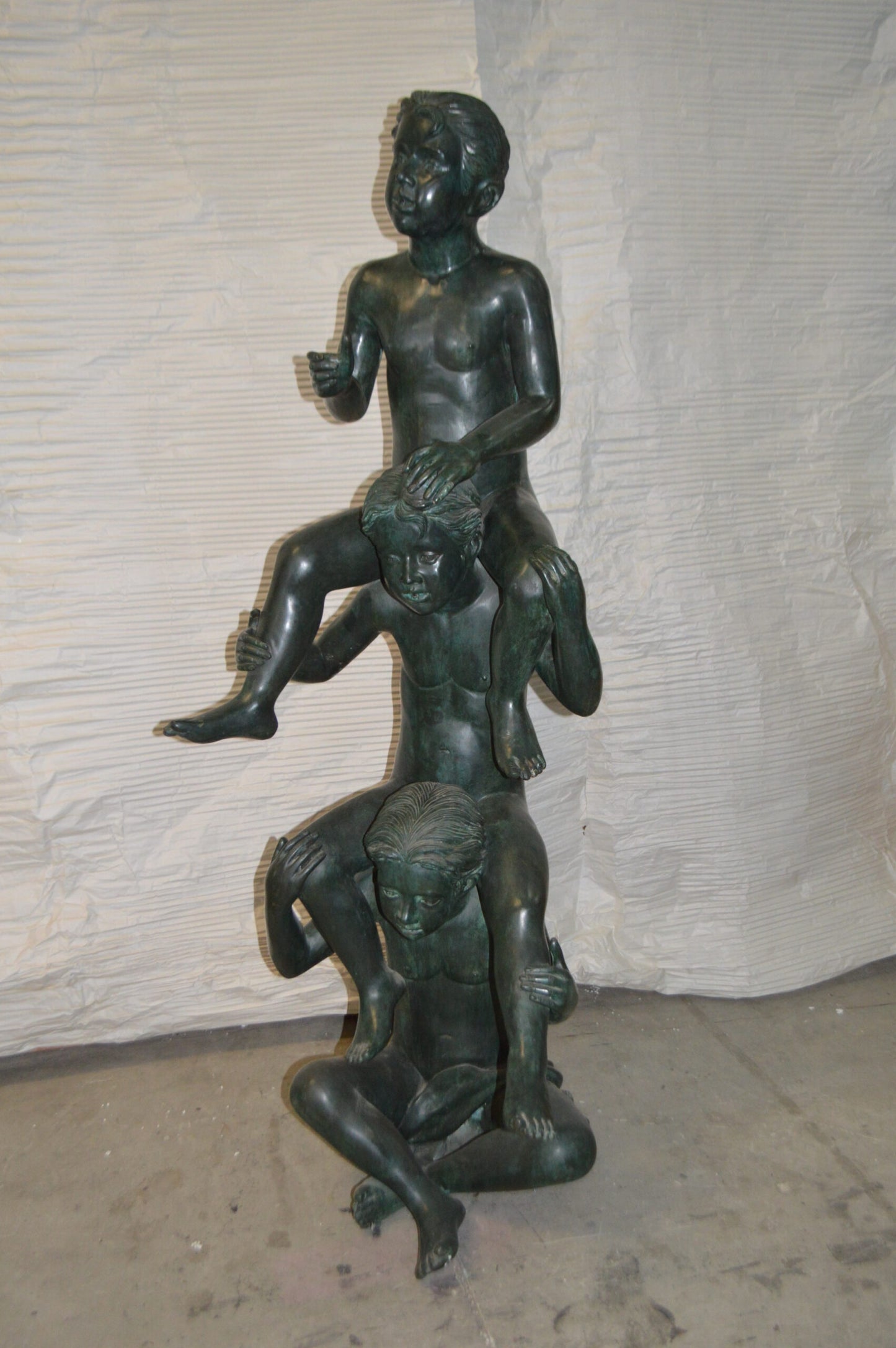 Three kids on Each other fountain Bronze Statue -  Size: 20"L x 27"W x 64"H.